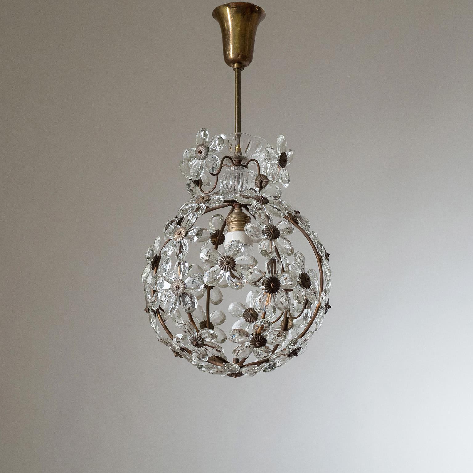 Charming Italian ceiling light from the 1930-1940s. Circular cage-structure adorned with crystals in flower shapes with brass details. One original brass and ceramic E27 socket with new wiring.
Measure: Body Height 36cm (14?).