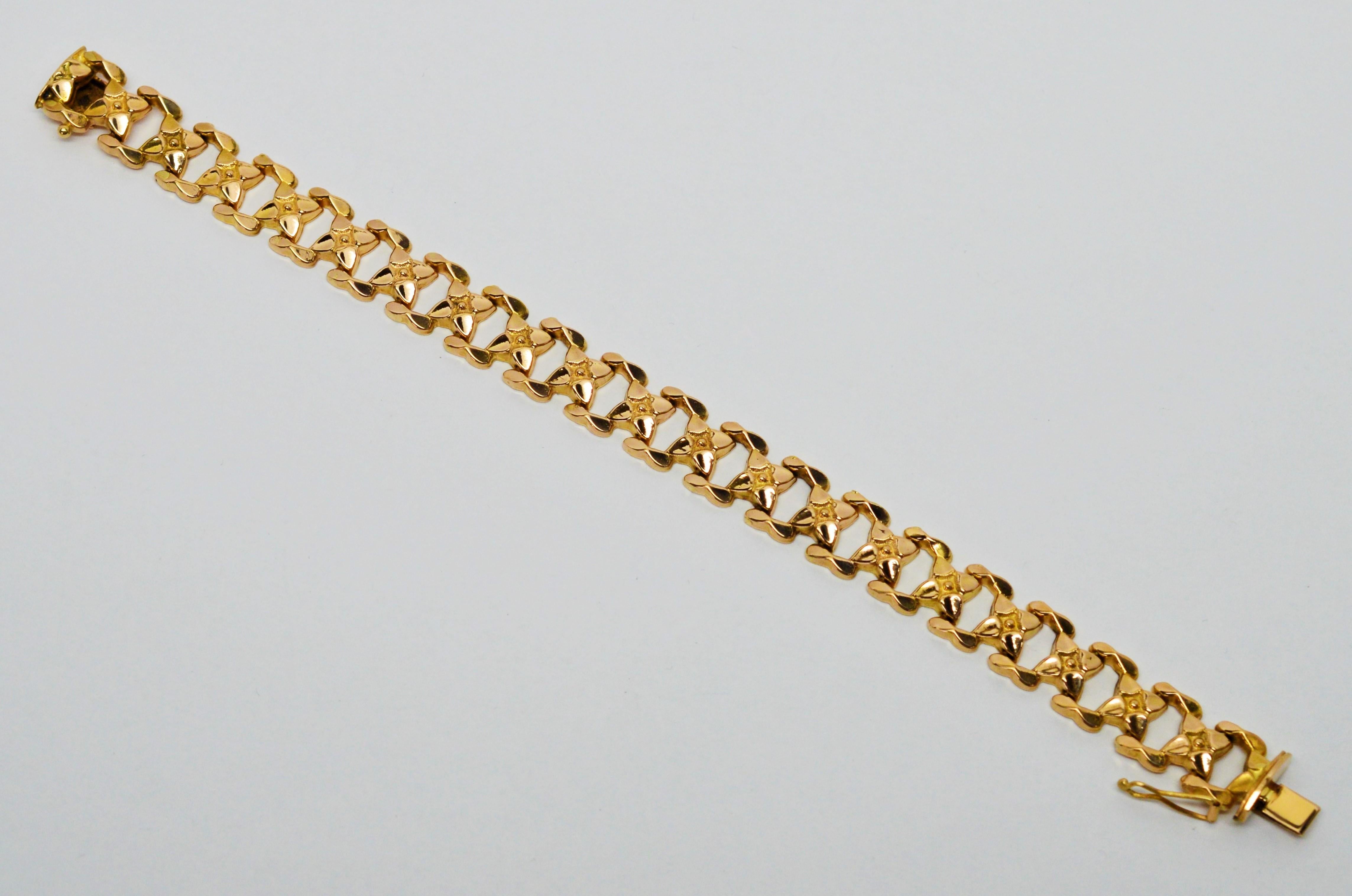 In bright eighteen karat 18K yellow gold, pretty floral links in a 7.5 inch length create this Italian made, quality gold bracelet.
Slender profile with 1/2 inch width.  Signed and stamped by maker. In gift box.  