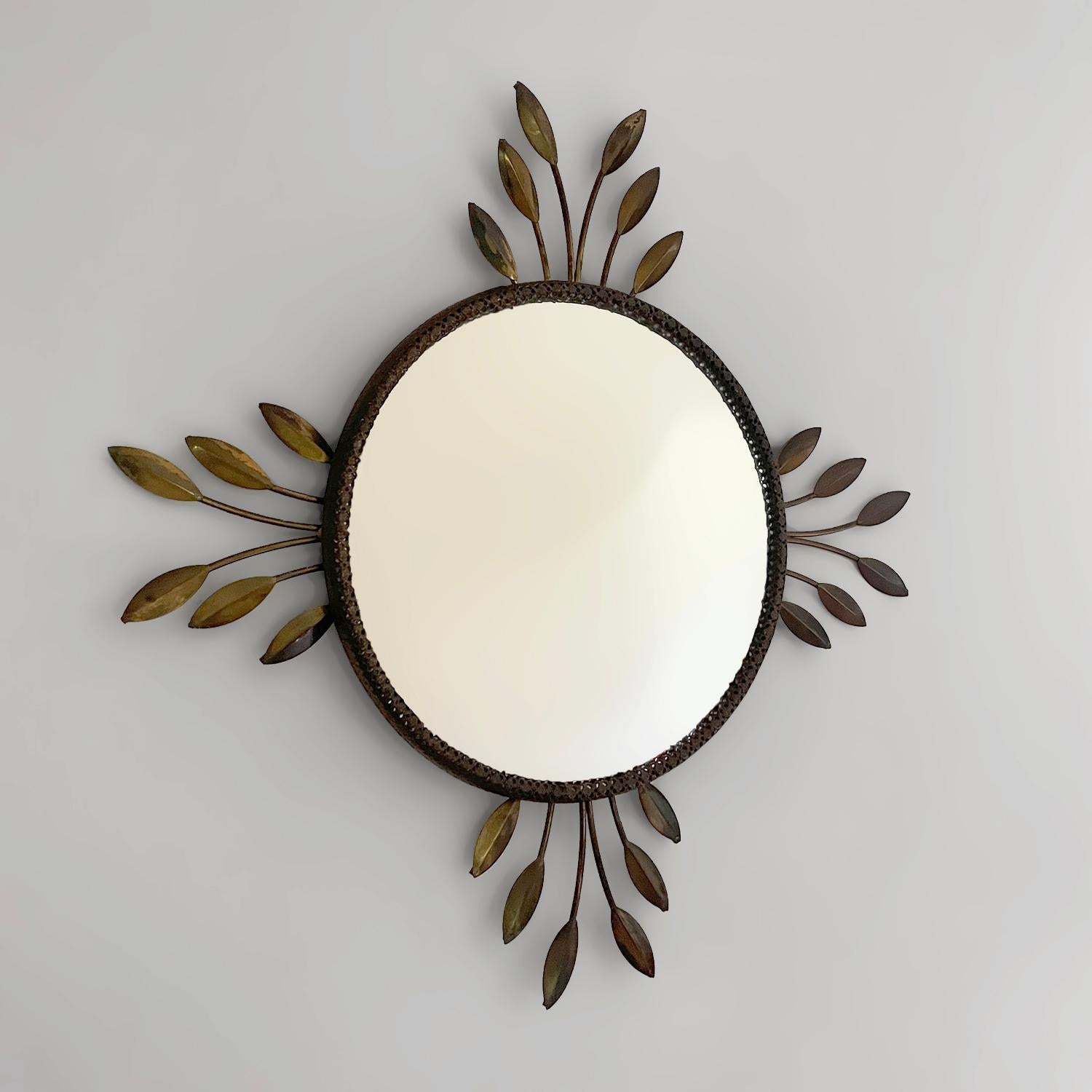 Italian floral sunburst convex mirror
Italy, circa 1950s 
This mirror will bring a smile to anyone who encounters it
Aged brass toned floral leaf detailing encompasses the embossed metal stamped frame
Each leaf unique in its composition
Natural