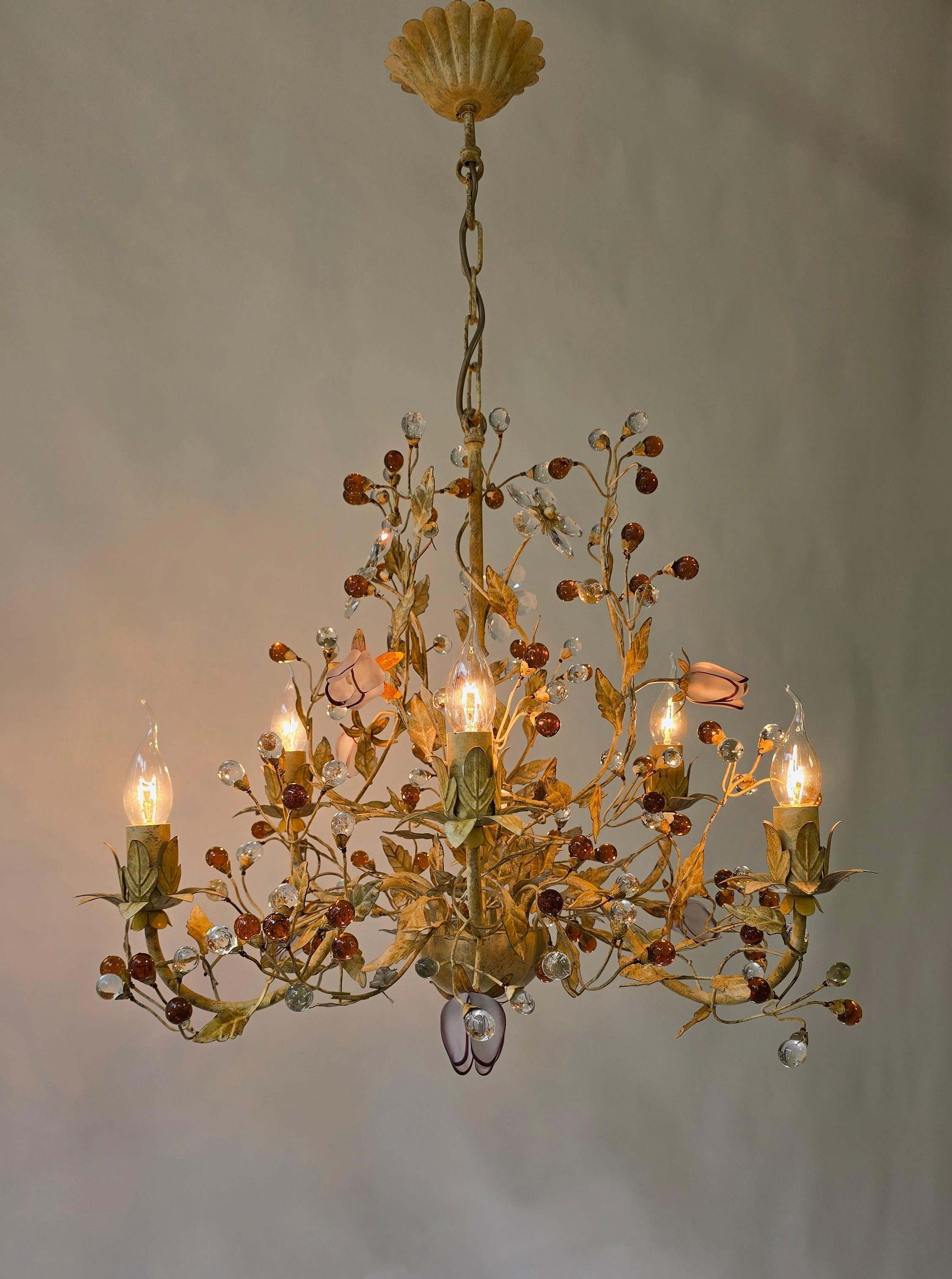 Italian Floral Tole Chandelier with Hand-Blown Glass Tulips, 20th Century

A romantic Italian floral chandelier with painted and patinated leaves, sparkling crystal flowers, and rare hand-blown glass tulips in lilac and purple. A striking decorative