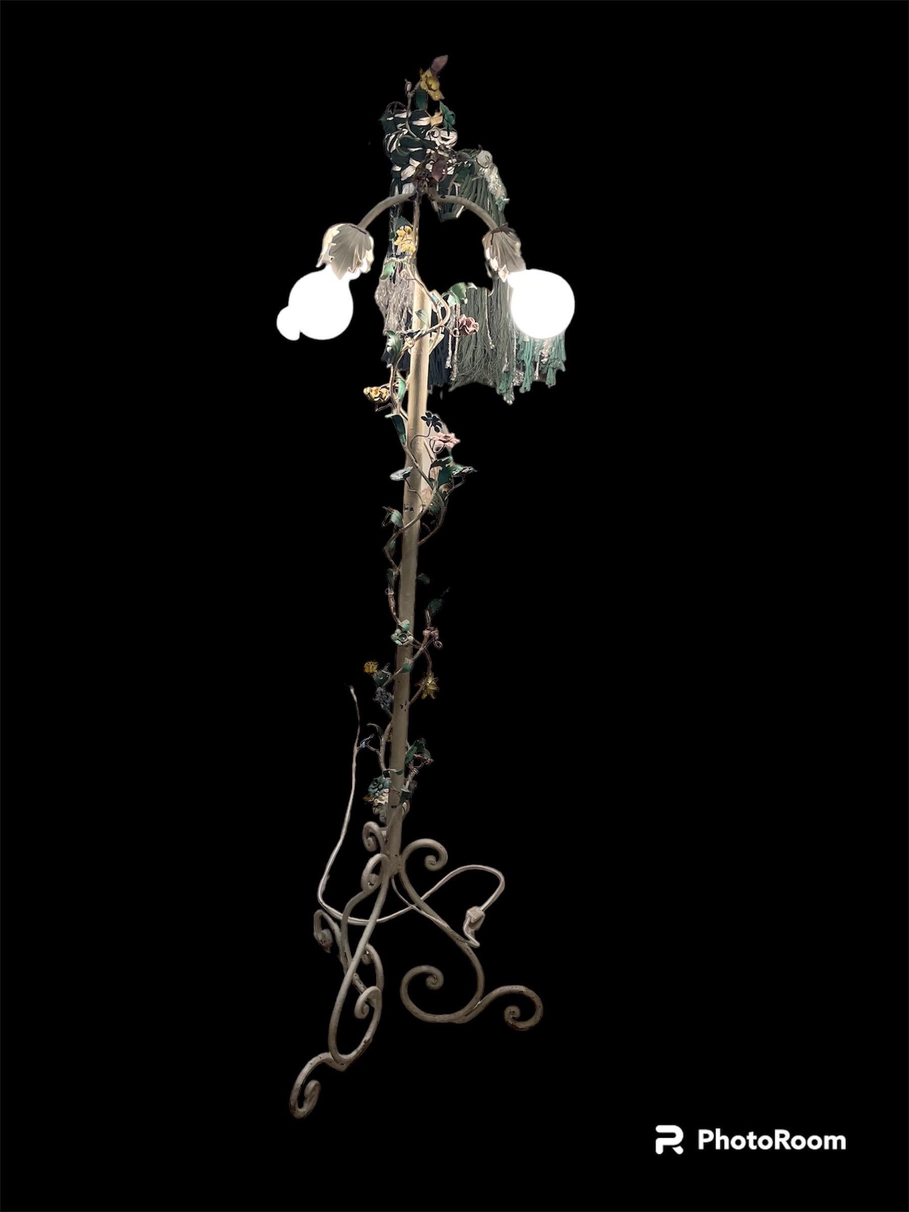 Floor lamp circa 1950's Italian painted tole two-light floor lamp with foliage and floral motif on the body.