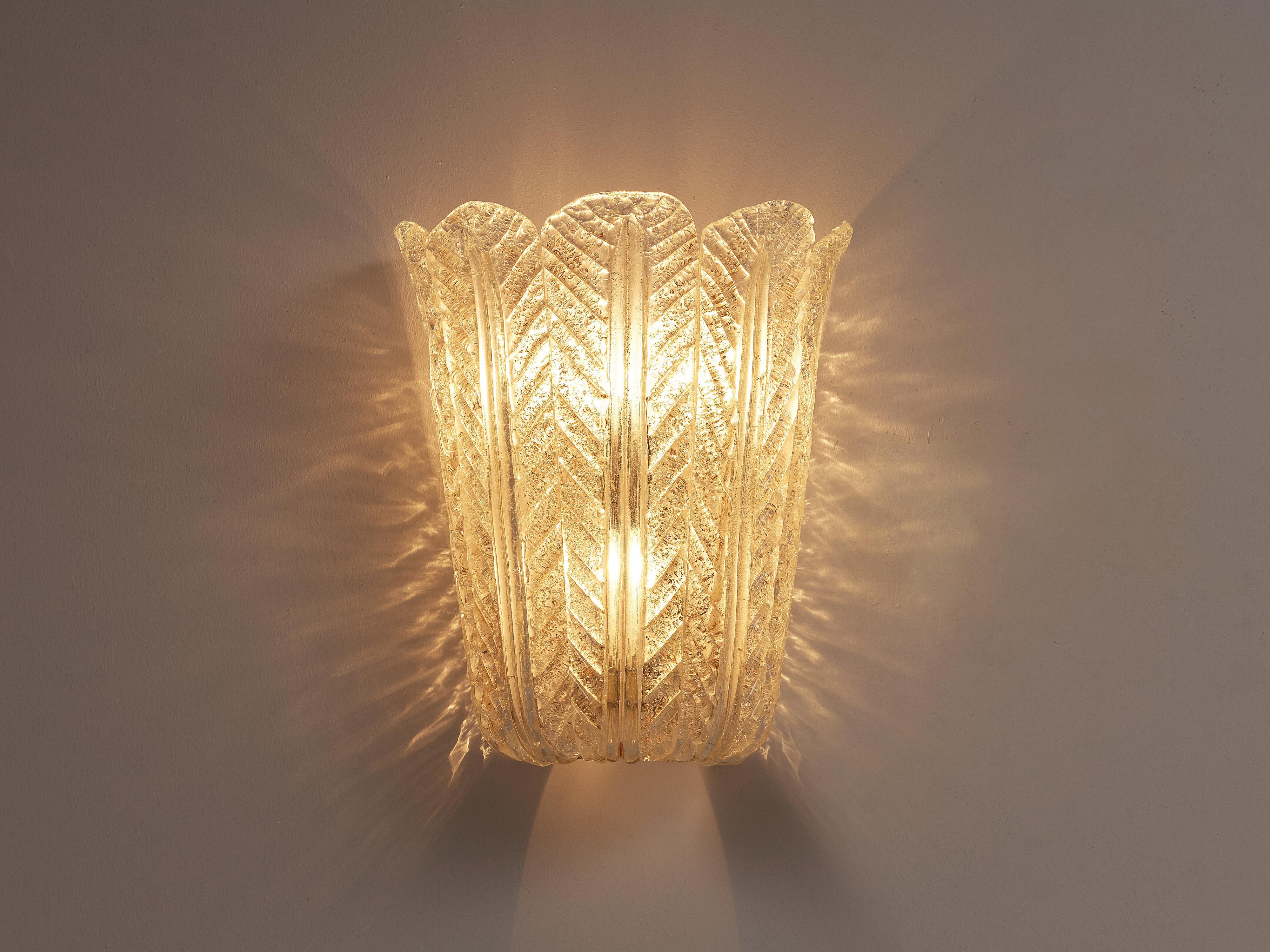 Italian wall light, structured glass, gold leaf, steel,  Italy, 1950s

This wonderful wall lamp bears strong resemblance to the designs of Venini. In the same style of the famous Italian glass and lamp manufacturer, this single wall lamp consists of
