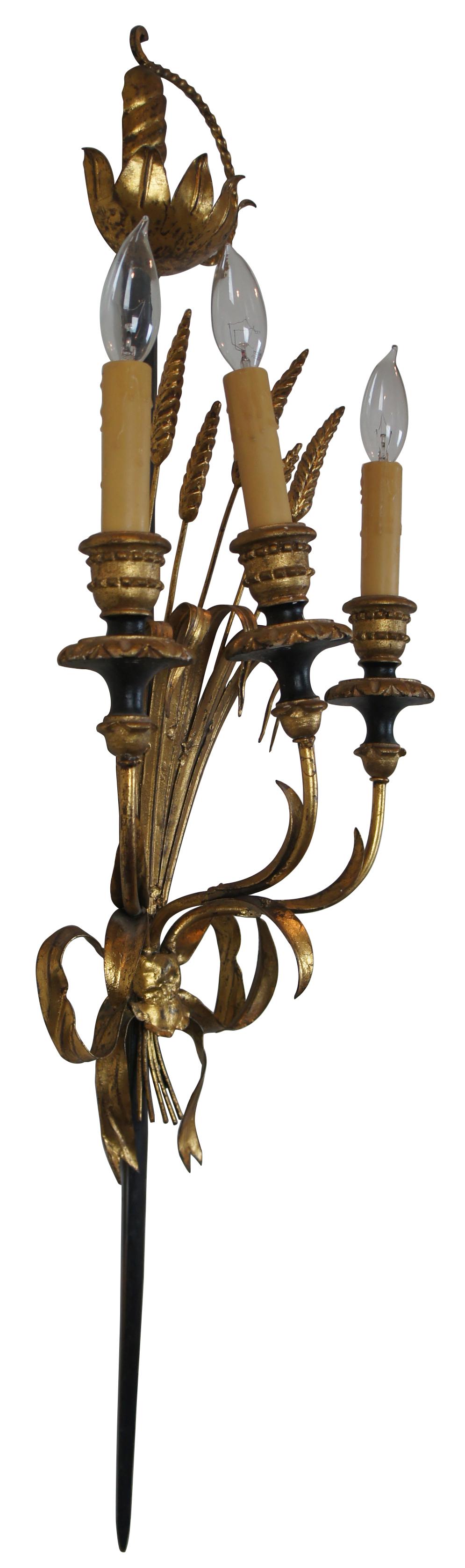 Vintage Italian toleware Florentine three-light wall sconce shaped like a small sheaf of wheat tied with a bow to a rapier or sword. Measures: 37”.
  