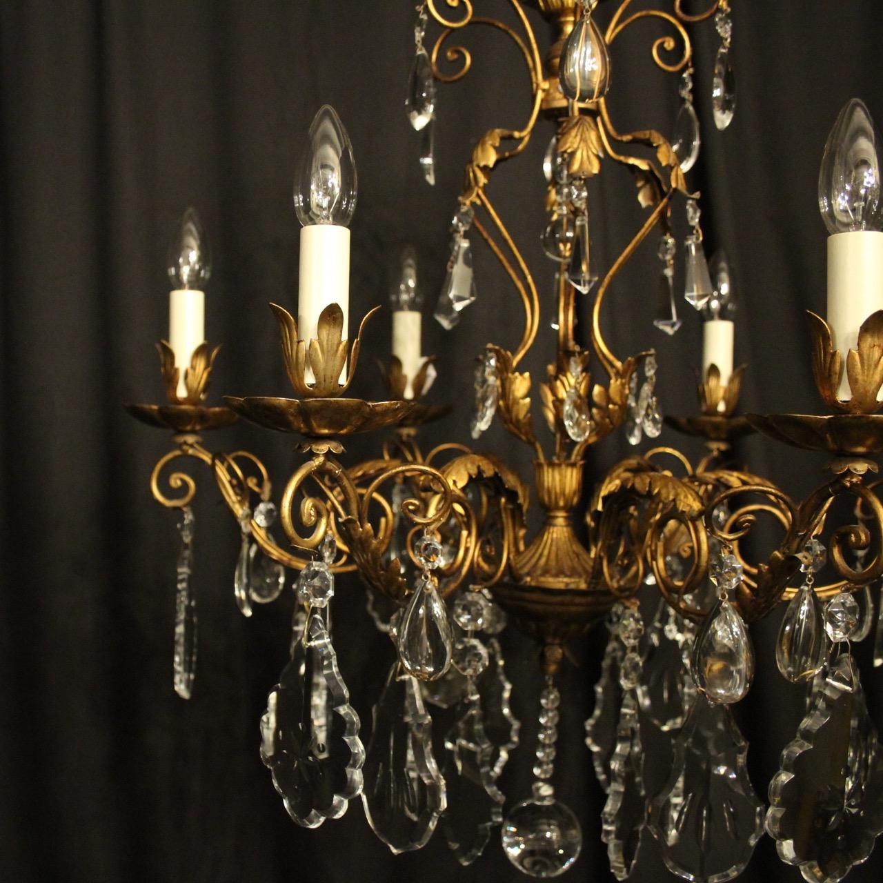 A decorative Italian gilded and crystal 6-light chandelier, the leaf scrolling arms with foliated bobeche drip pans and leaf candle sconces, issuing from a cage form leaf clad wirework interior with scrolling wirework canopy, decorated with nice