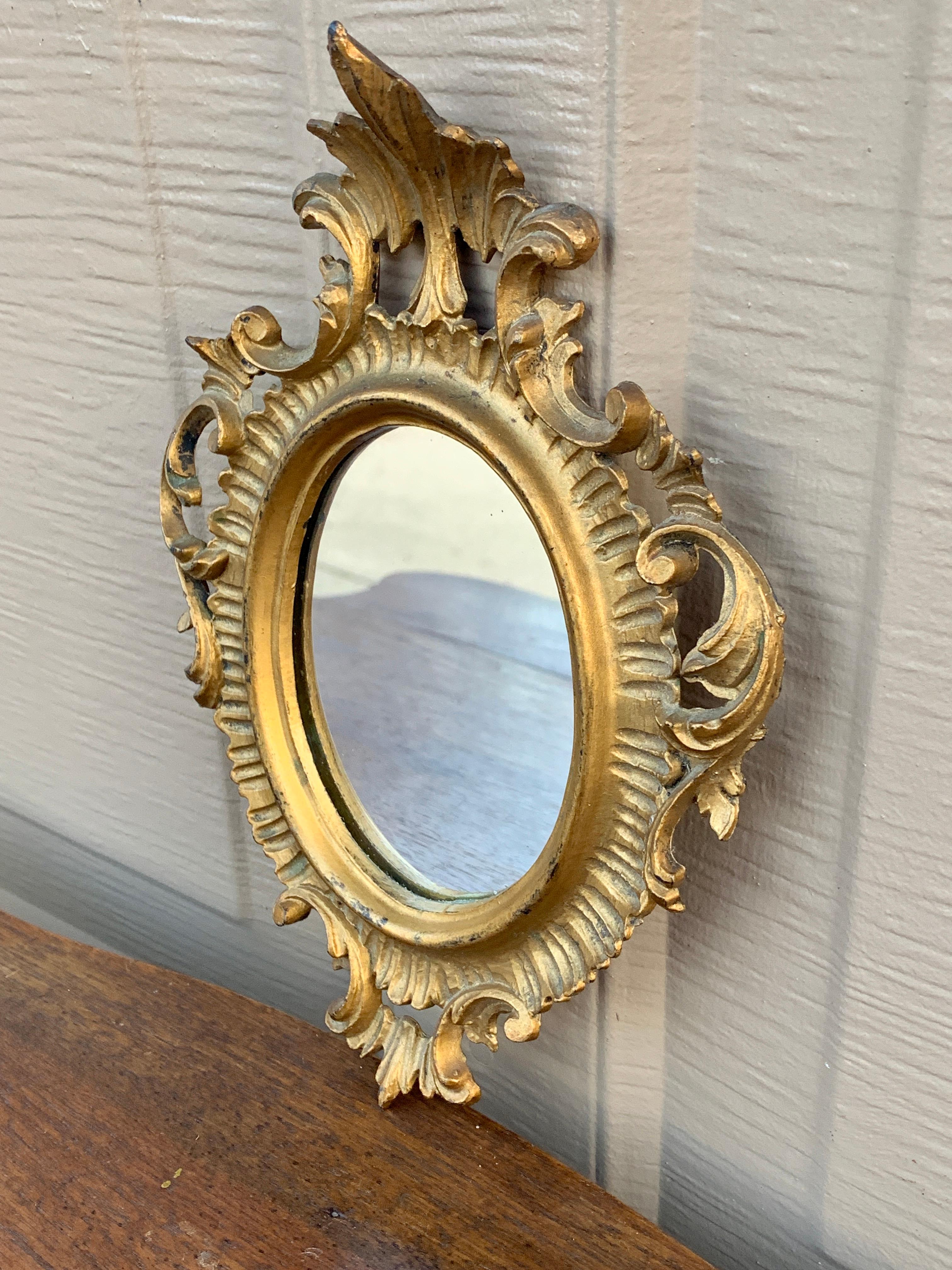 A stunning Italian Florentine baroque rococo style wall mirror

Italy, Circa 1960s

Gold gilt wood, with mirror.

Measures: 6