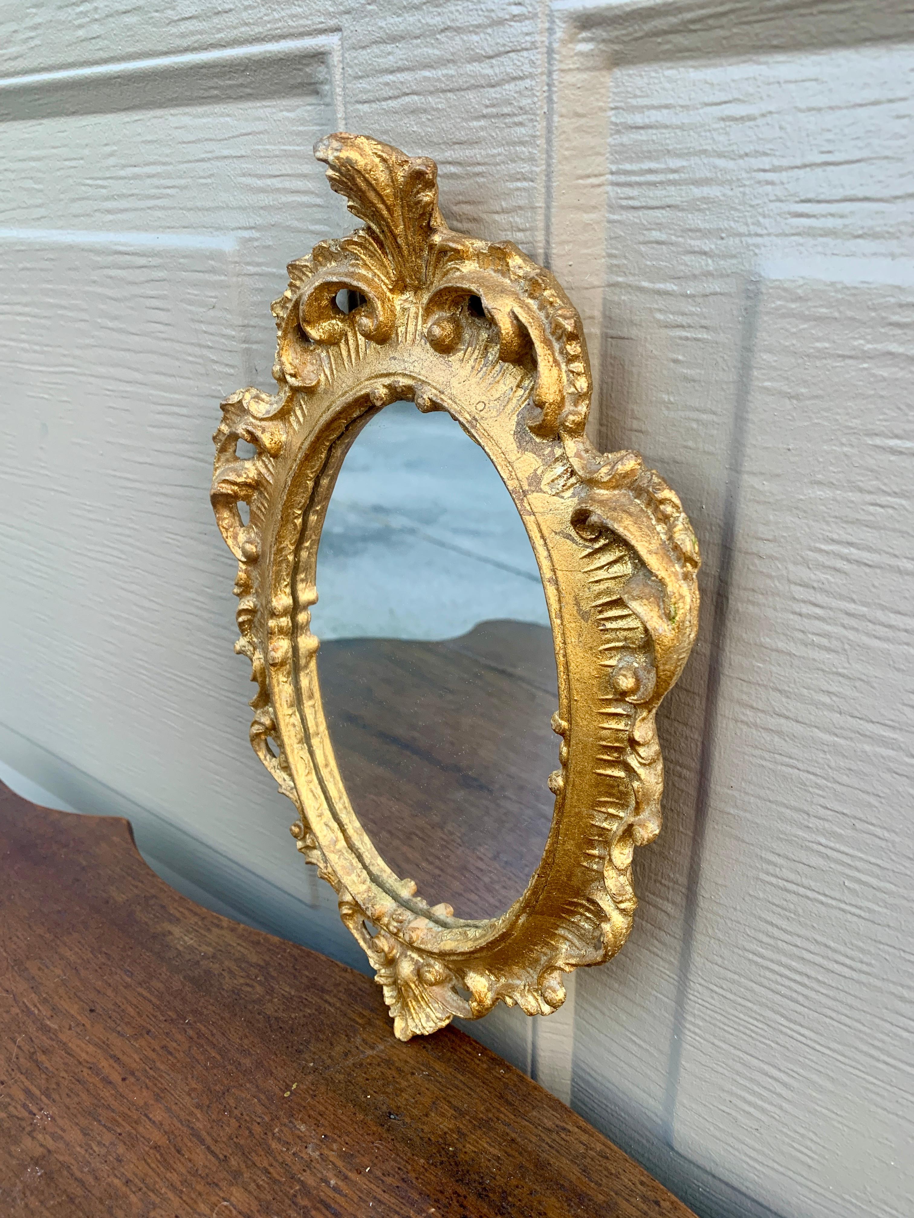 A stunning Italian Florentine baroque rococo style wall mirror

Italy, Circa 1960s

Gold gilt wood, with mirror.

Measures: 7.25