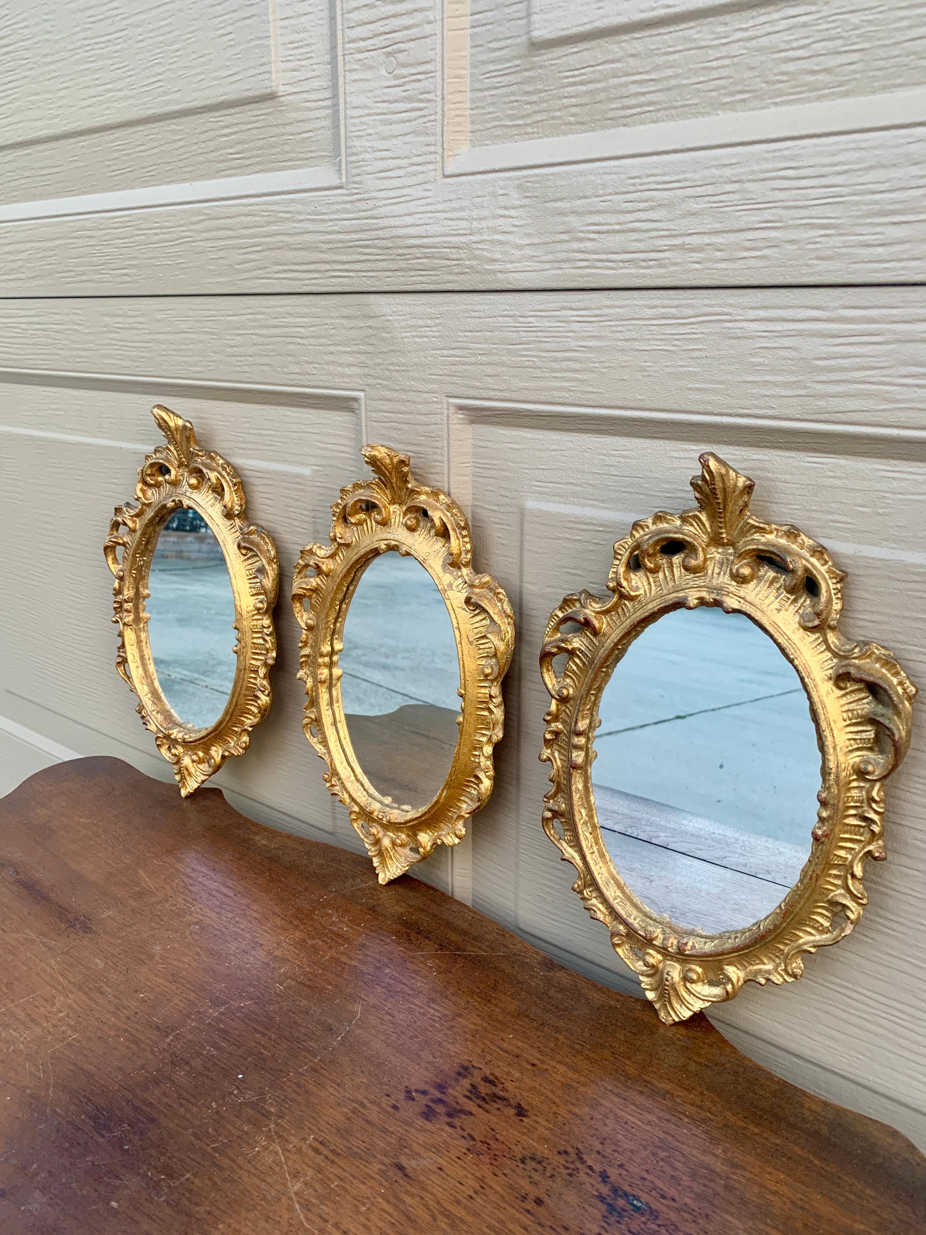 A stunning set of three Italian Florentine baroque rococo style wall mirrors

Italy, Circa 1960s

Gold gilt wood, with mirror.

Measures: 7.25