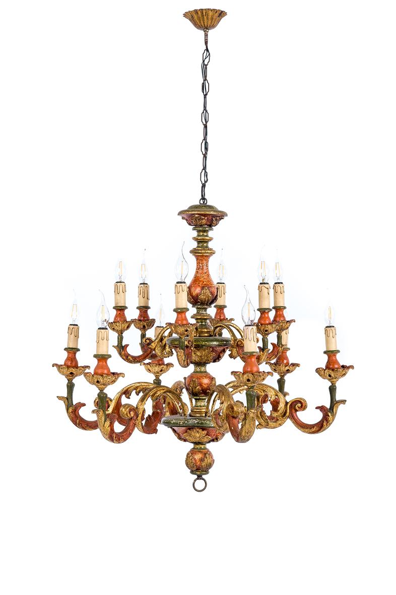 A beautiful two-tier chandelier with twelve lights that was made in the Italian region of Florence, circa 1910.
The chandelier is made in polychrome hand carved wood. The arms feature C-scrolls acanthus and other baroque motifs. The color
