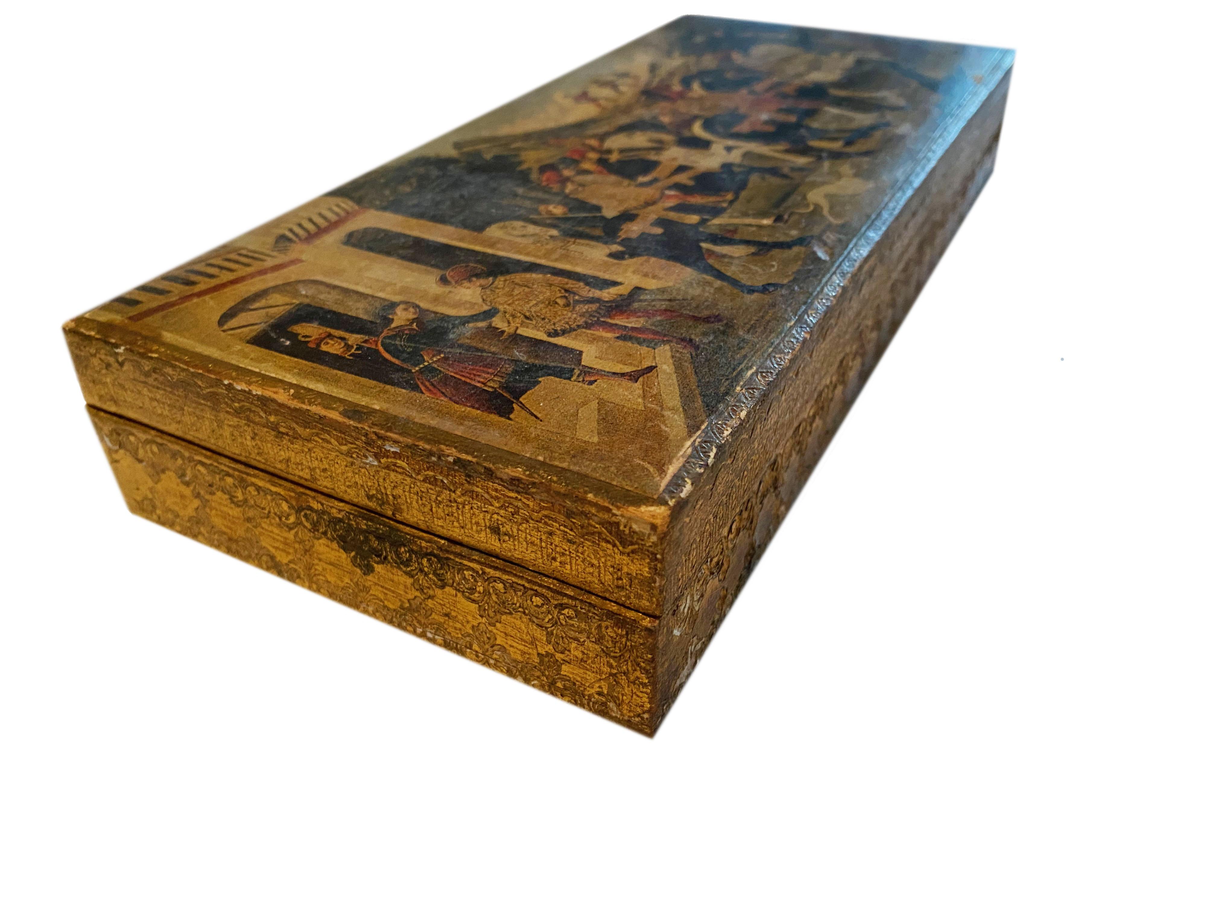 A wonderful Italian Florentine box with a festive European scene on top with horses, the Alps, dogs and more. Box has a hinged top.