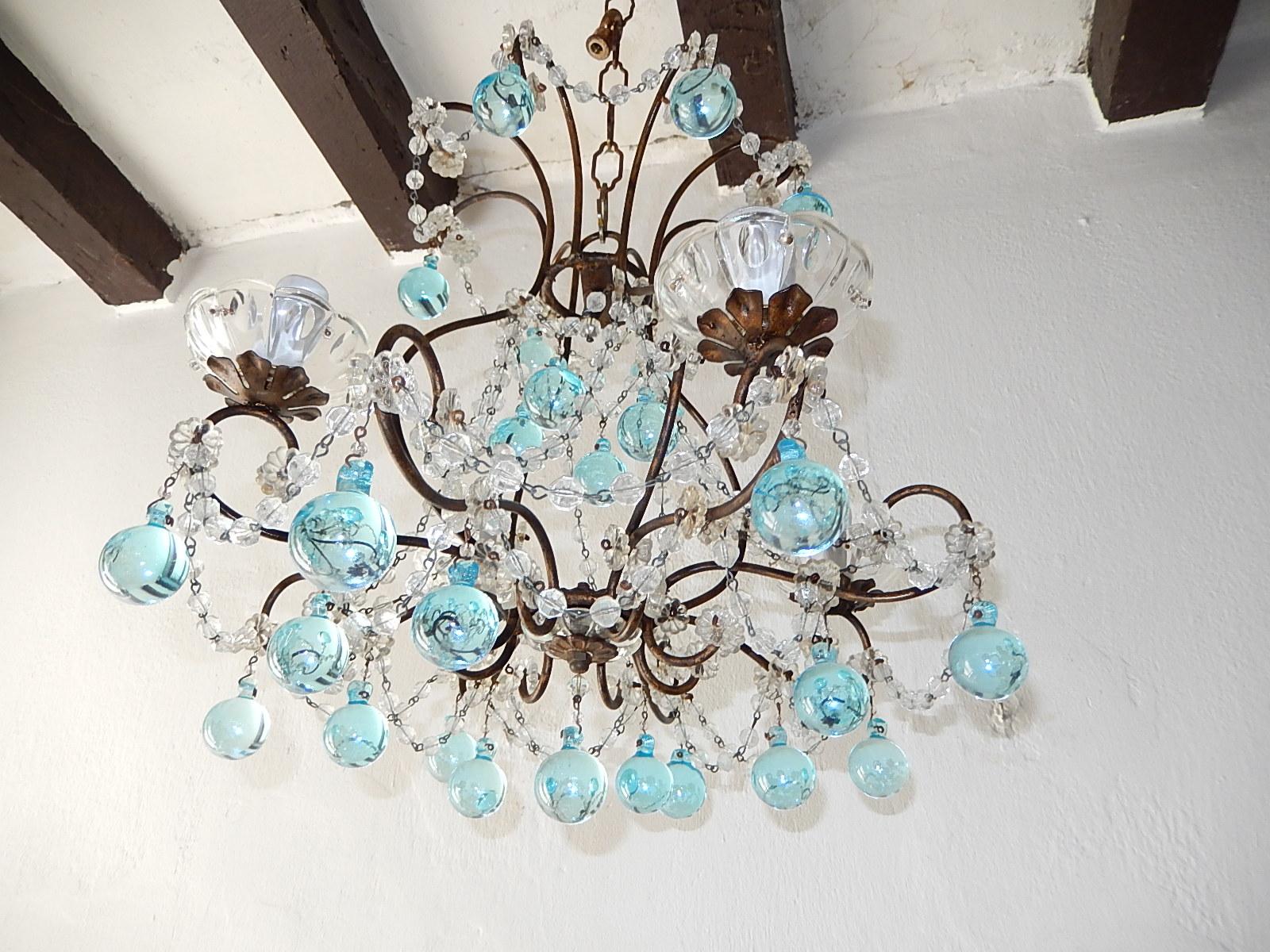 Housing 4 lights sitting in crystal bobeches, dripping with crystal balls. Swags of crystal and florets throughout. Murano aqua blue drops. Adding 8 inches of original chain and canopy. will be re-wired with certified sockets appropriate for country