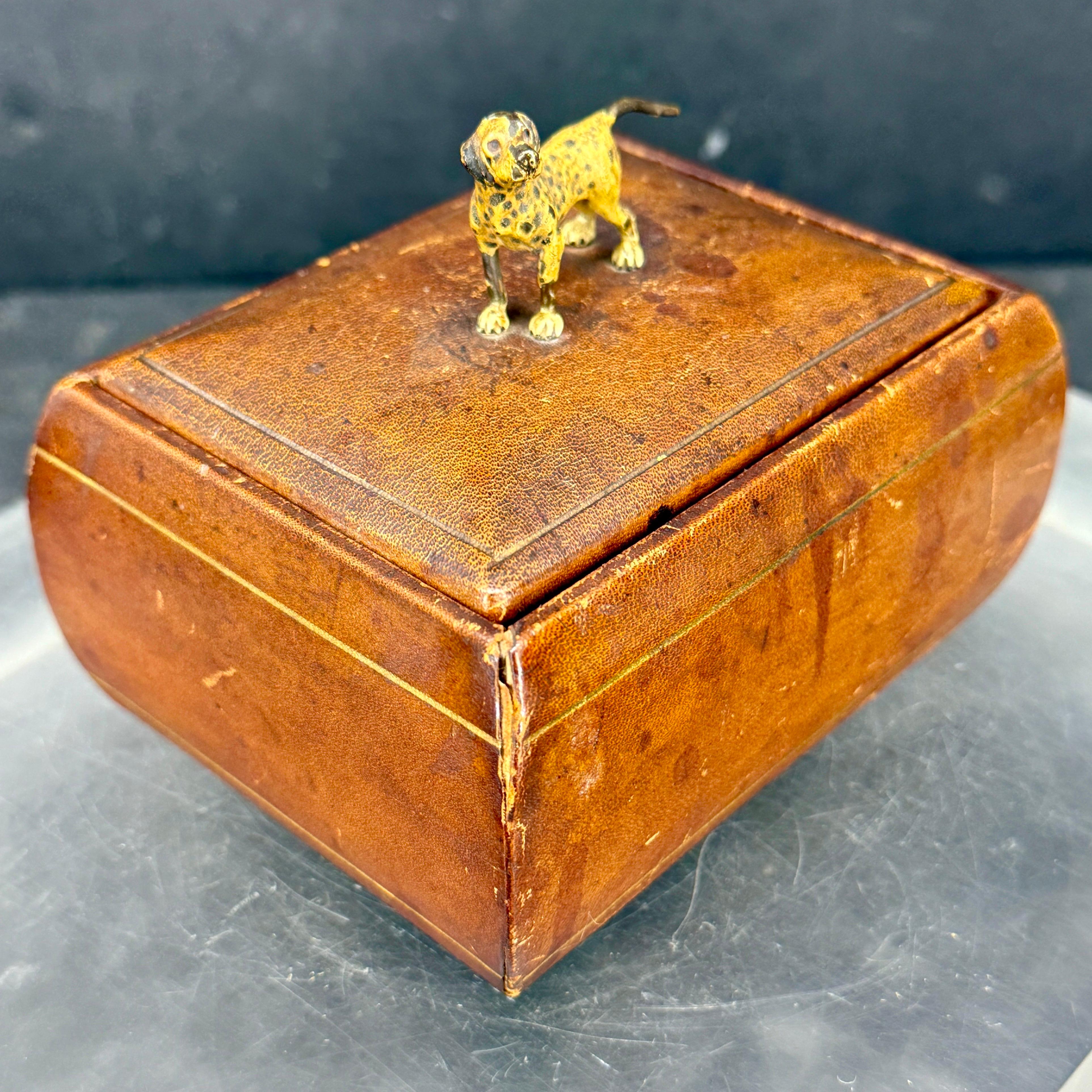 Very charming Mid-Century rectangular Italian hand crafted box in leather and gold embossed with a charming dog affixed on the lid. This box can be used to store your favorite pieces of jewelry or trinkets on a vanity or dresser. 