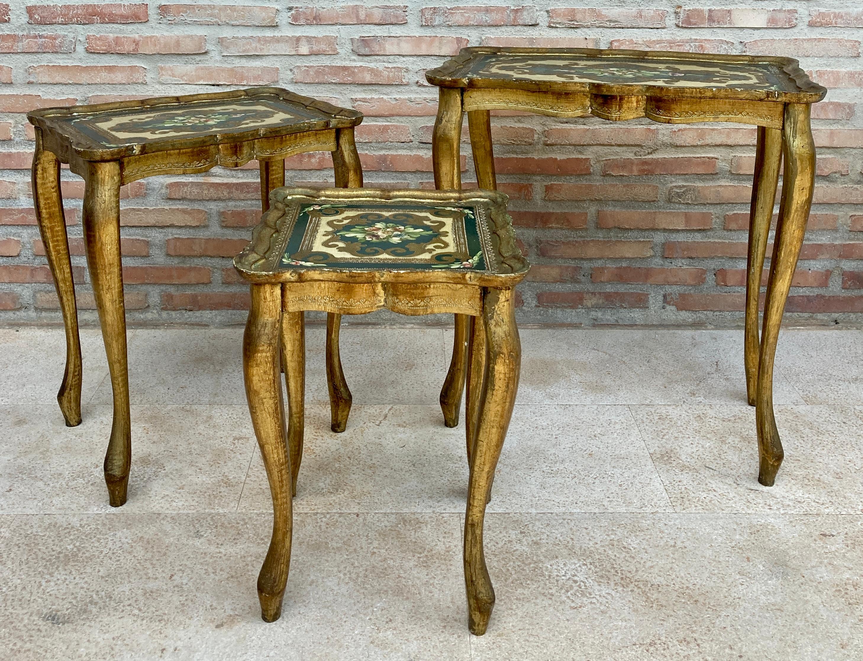 Vintage Italian Florentine neoclassical midcentury patinated nesting tables- set of three 1960s 
Lovely graphics ornate figural design scalloped trim. 
Original preowned unrestored condition and presentation. 
This stylish nest of 3 giltwood side