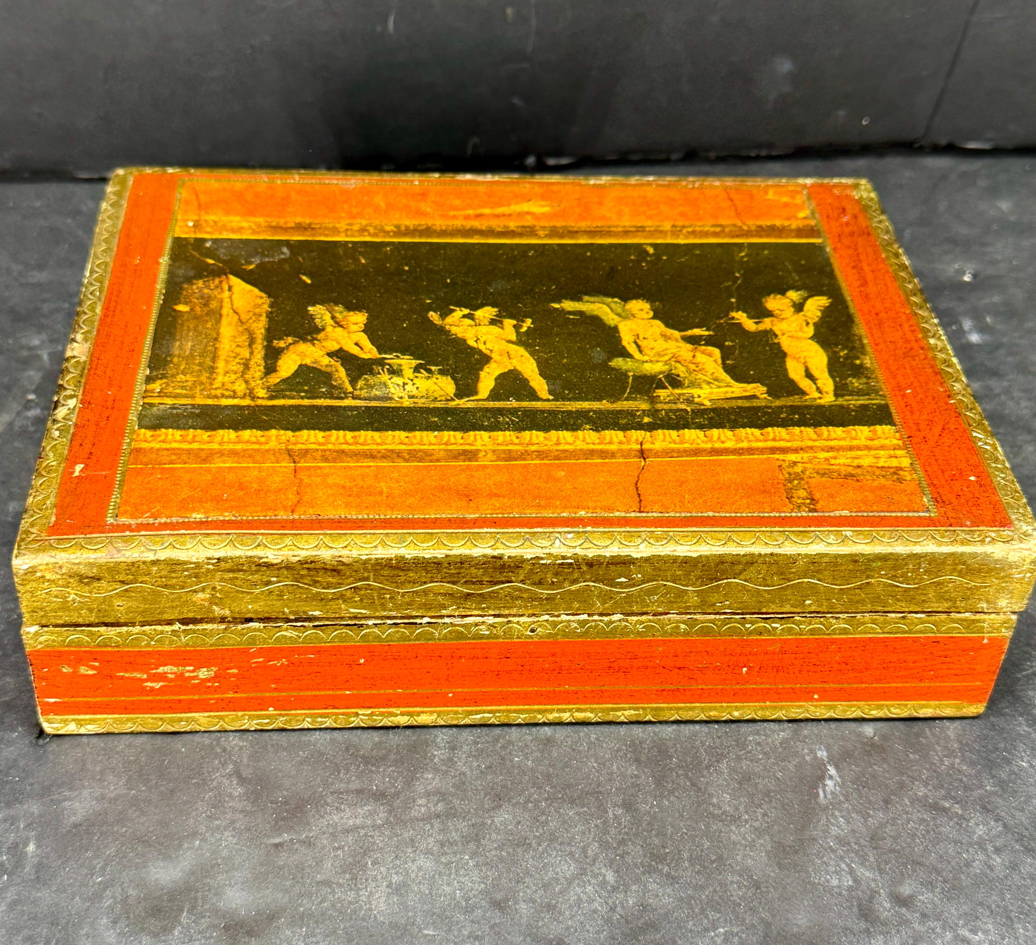 Large charming Italian Mid-Century Florentine hand crafted box with classical scenes. This gilt-wood box with red, gold and black detailing has four compartments and can be used to store your favorite pieces of jewelry as well a stand alone piece on