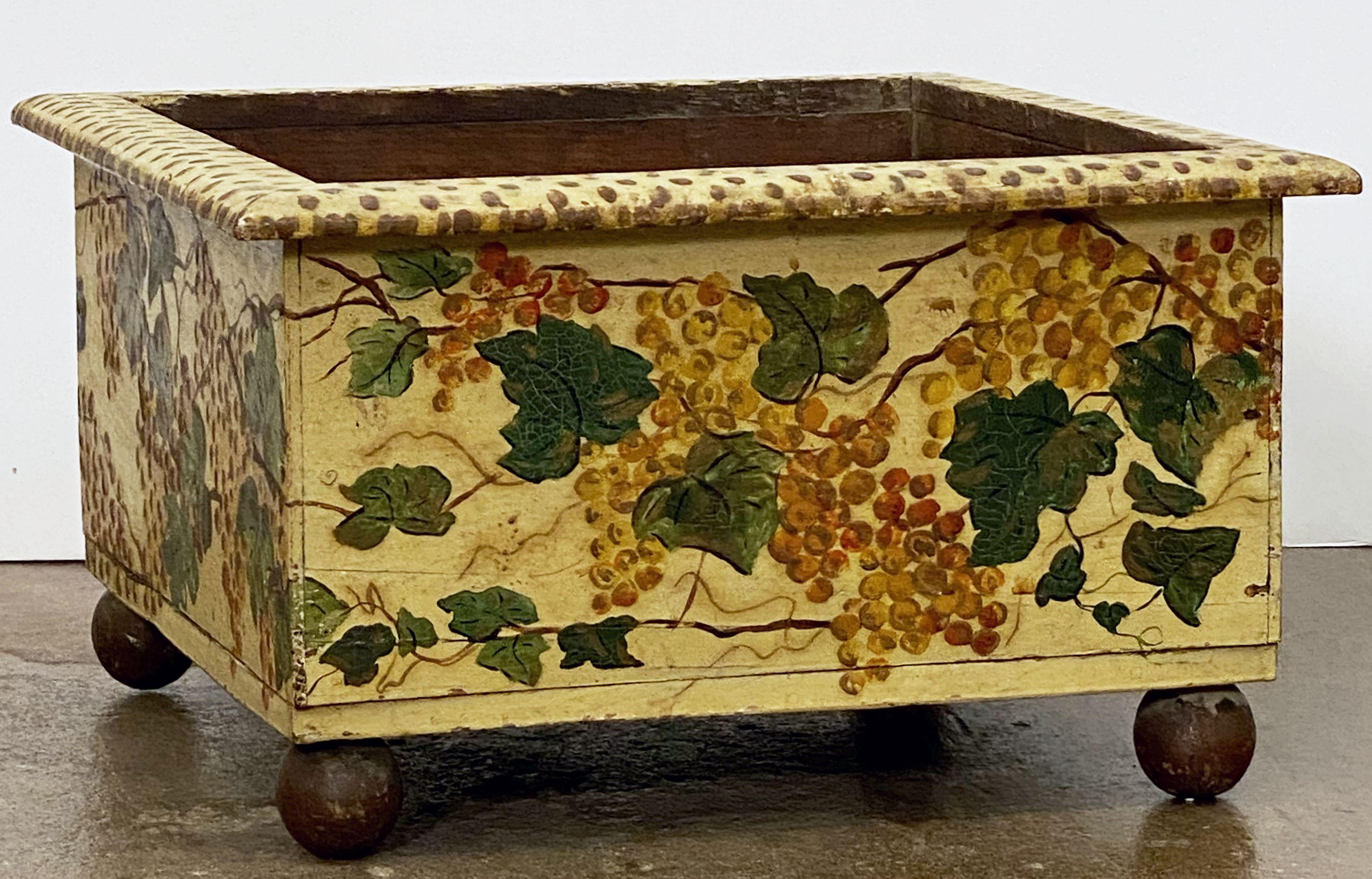 A fine early Italian square flower box or planter from the 19th c., featuring a moulded frame edge with a lovely painted design of grapes and resting on four ball feet.

Bought in Parma, Italy.