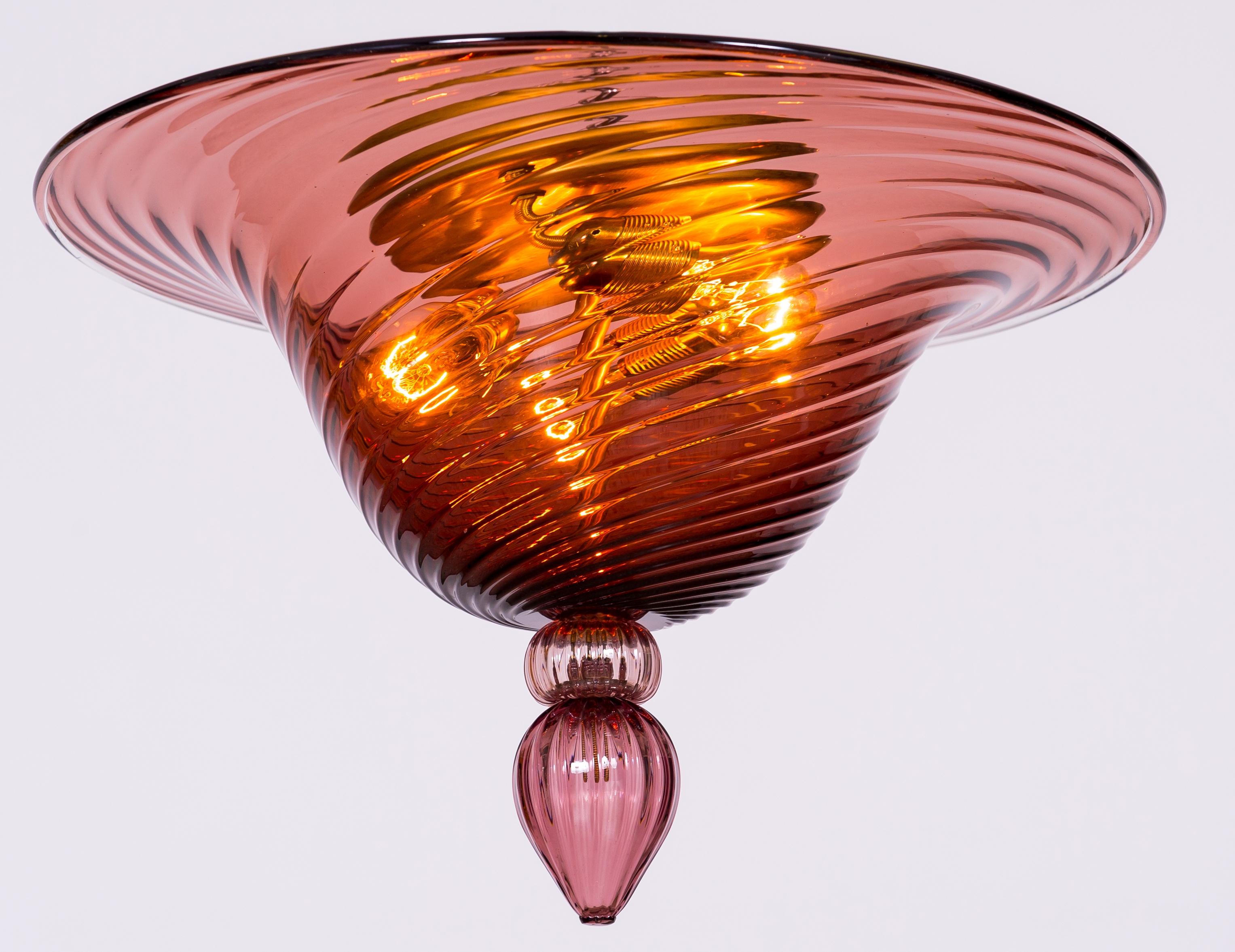  Amethyst Flush Mount in Blown Murano Glass Contemporary, Italy
This is a Murano masterpiece constituted of a mail bowl with twisted carved lines, accommodated in a brass framework having three lights. At the bottom, of the flush mount, a round ring