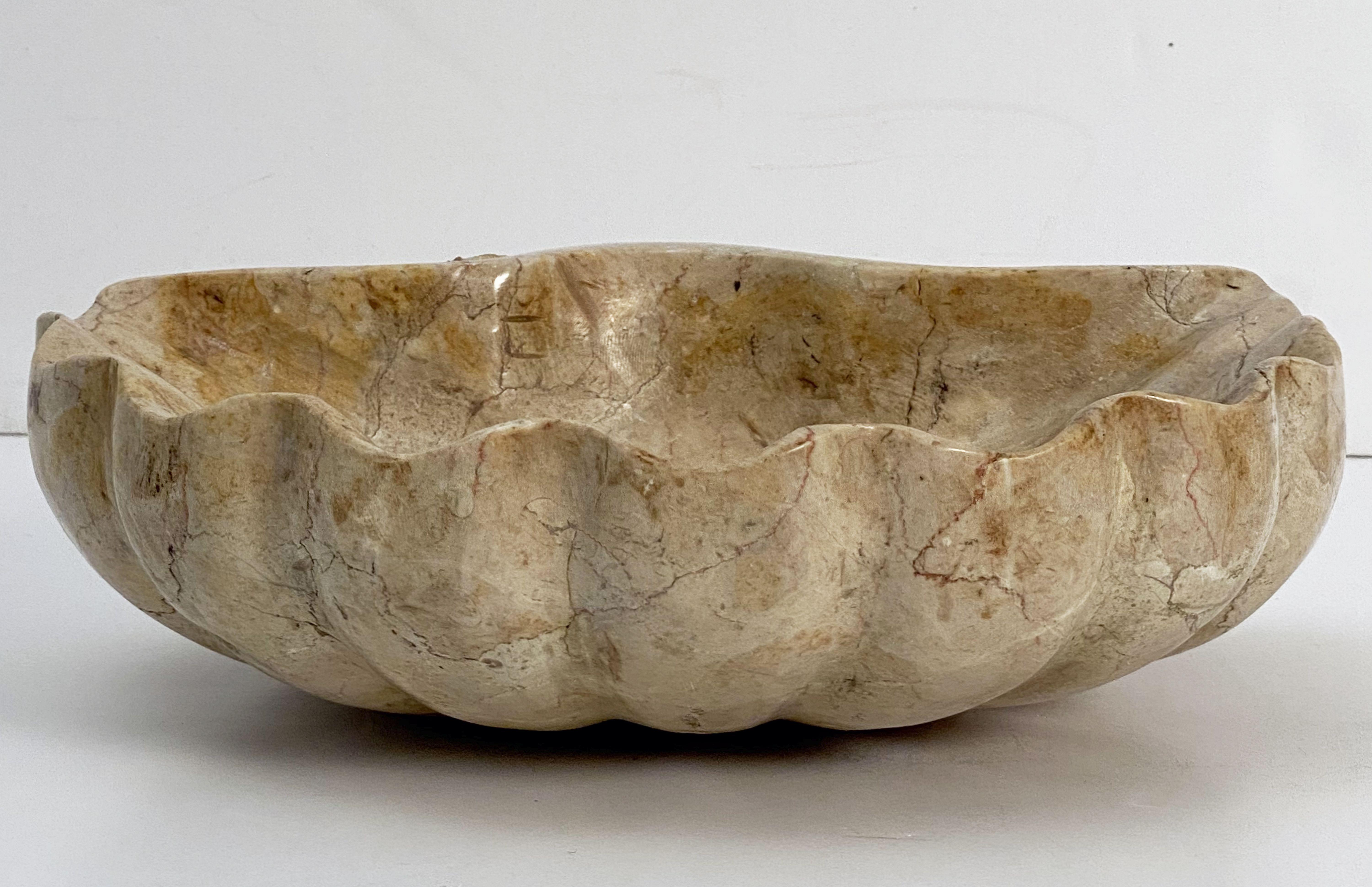 A fine Italian font or basin bowl centerpiece of figured marble featuring a carved shell design.

Dimensions are H 3 3/4 inches x W 11 1/2 inches x D 11 1/4 inches.