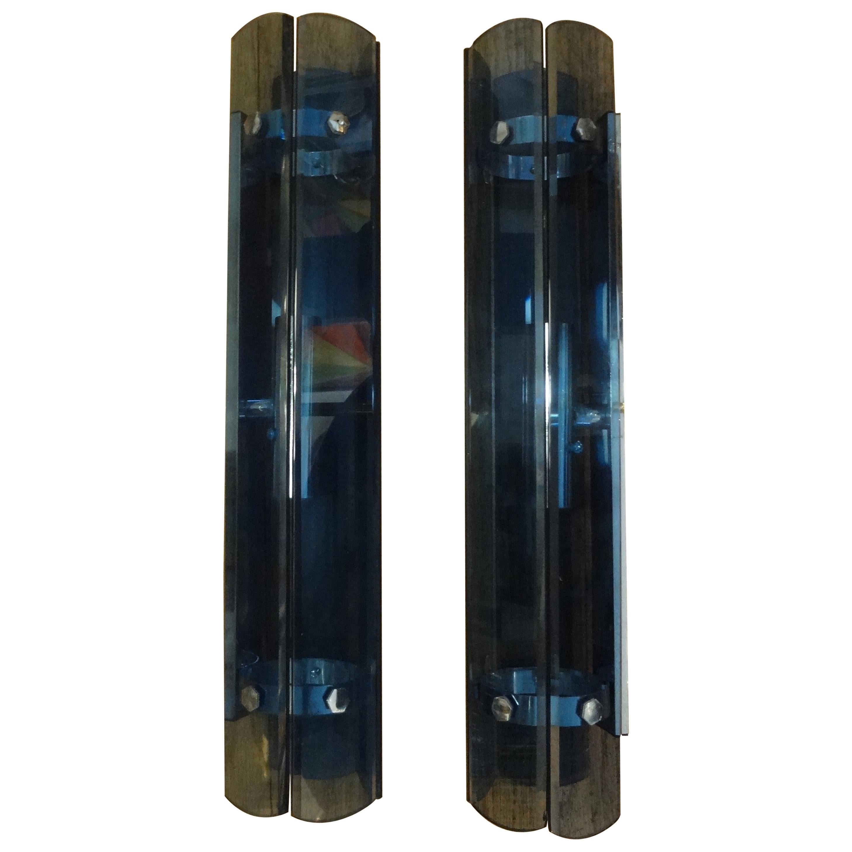 Stunning pair of Italian Fontana Arte style quadrilateral blue glass sconces. These great mid-century Max Ingrand for Fontana Arte style Italian blue glass sconces have four sides of beveled glass on chrome structures. Each sconce has been newly