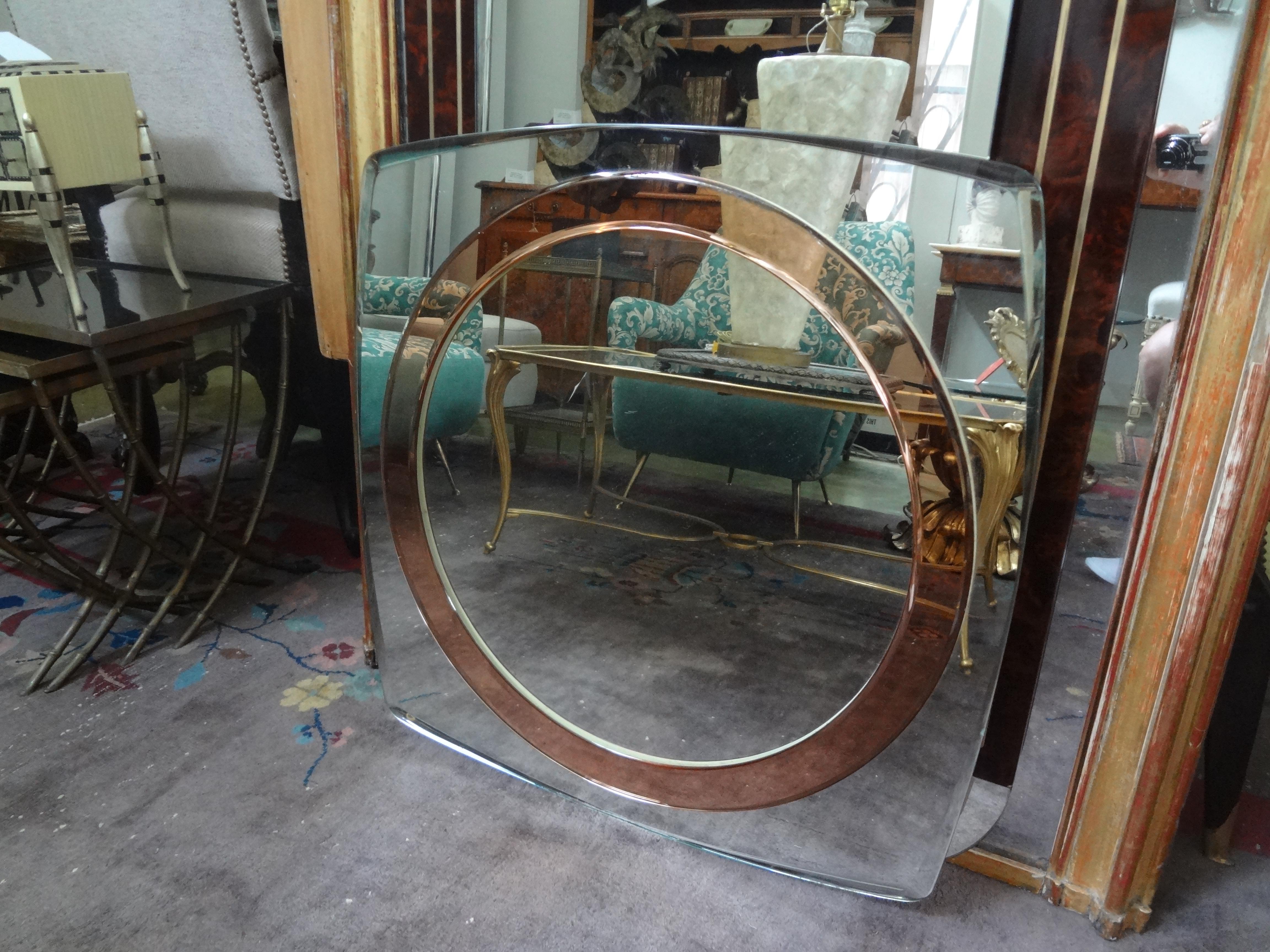 Interesting Italian Fontana Arte style mid century square shaped beveled mirror with an inset rose colored bevel circle. This unusual beveled mirror inspired by the work of Max Ingrand of Fontana Arte is both stunning and functional. This versatile