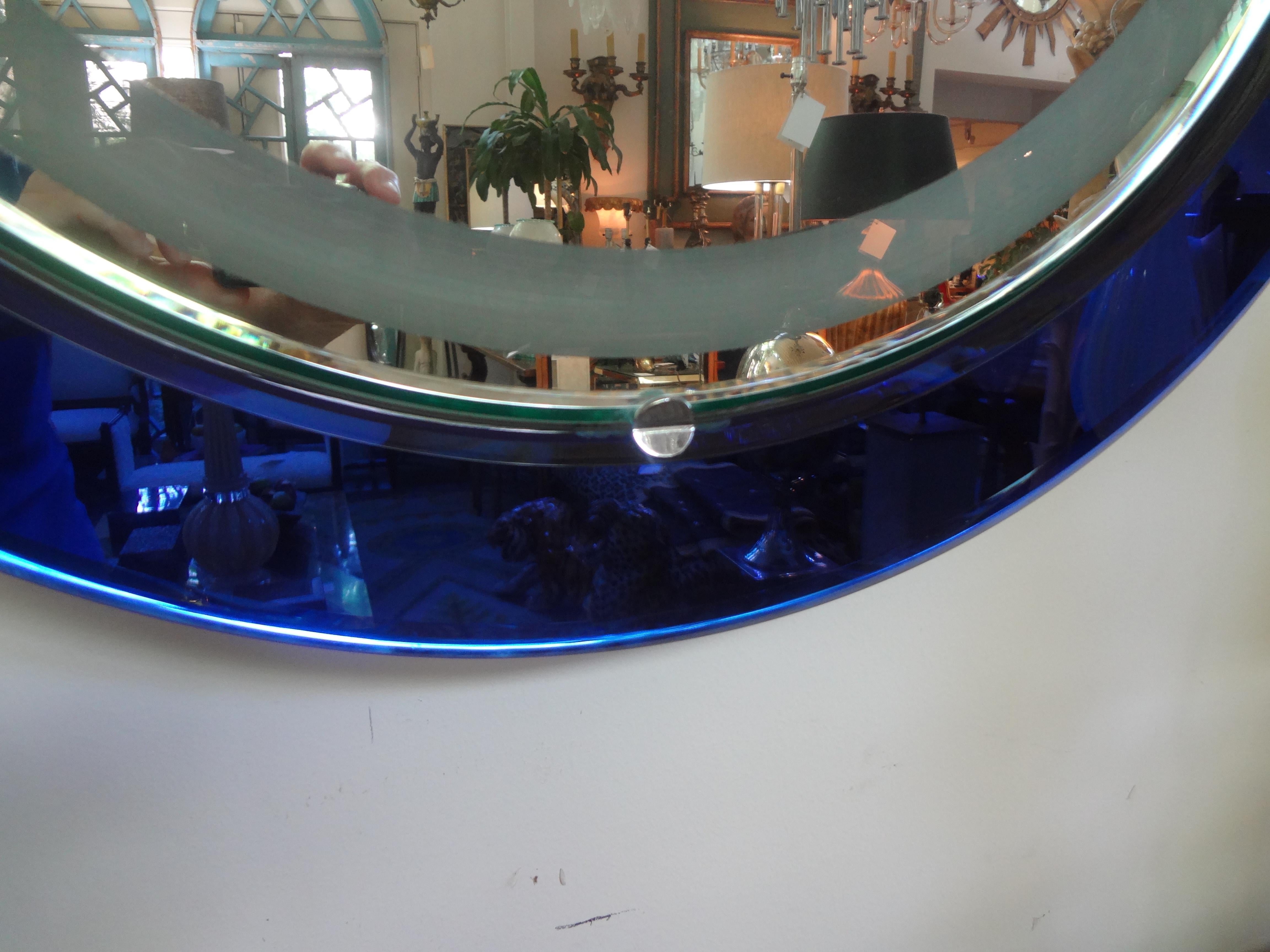 Unusual Italian Fontana Arte style round cobalt blue backlit mirror with a frosted interior band. This stunning Italian midcentury mirror is in beautiful condition and has been newly wired for the U.S. Market. Our Italian Hollywood Regency blue