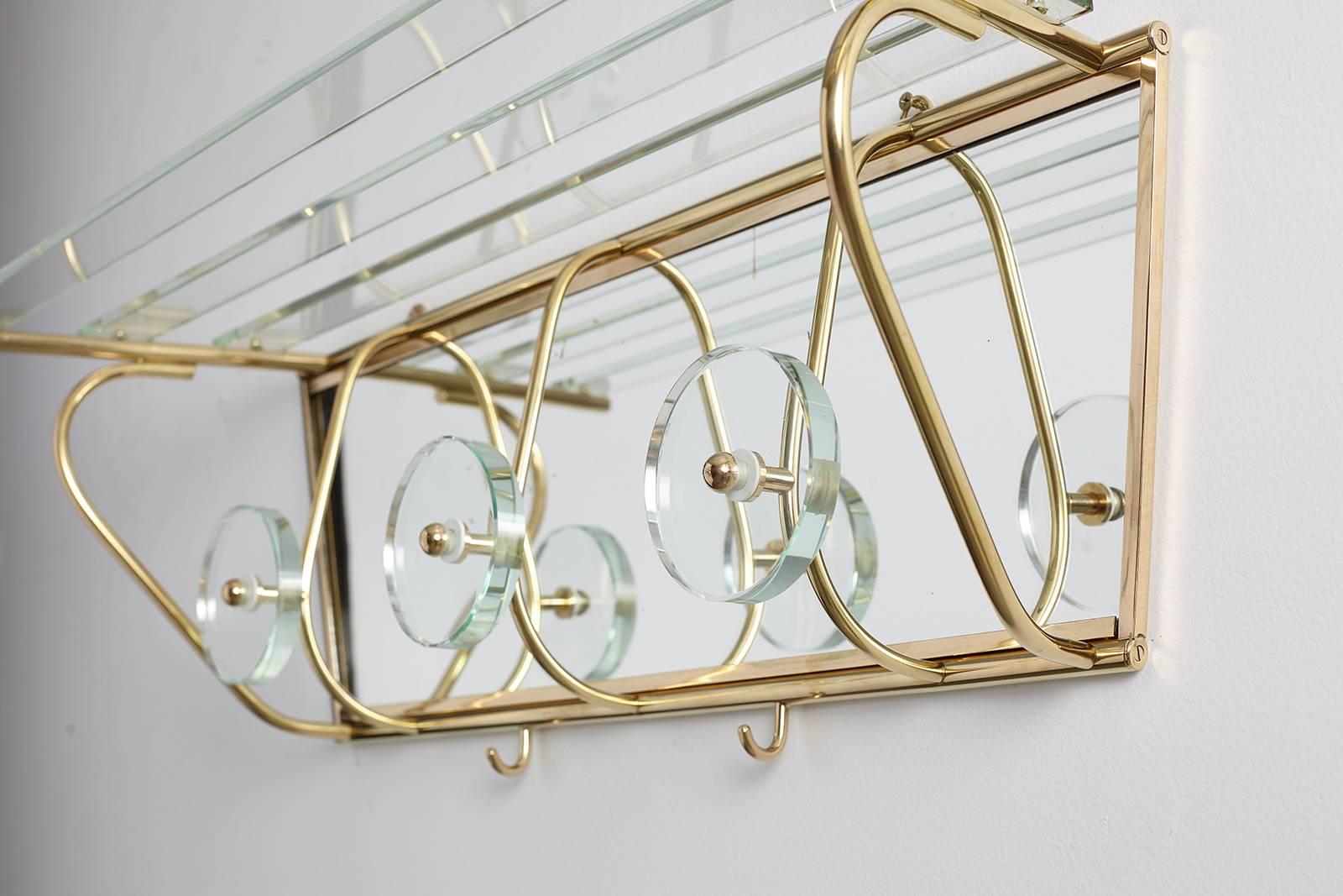 Beautiful mirrored coat rack in the style of Fontana Arte and Cristal Art. 

Delicate slatted glass shelf rods and four hooks provide an elegant and proper source for storage. Two brass hooks for additional storage on base of rack.