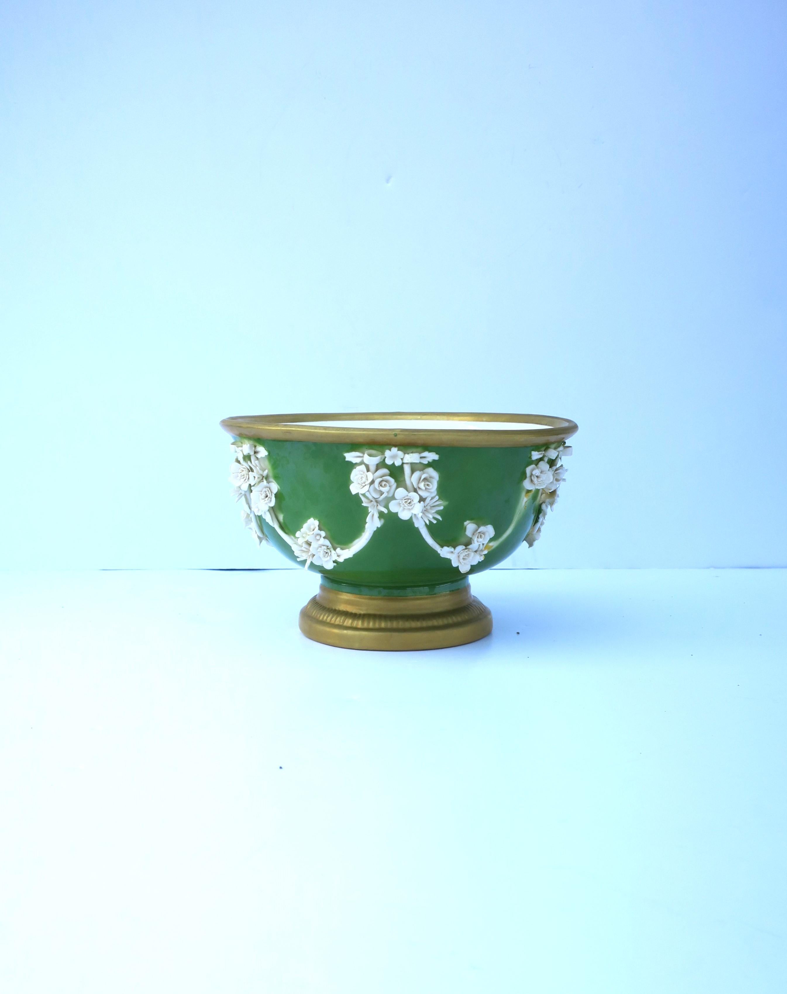 A beautiful Italian porcelain footed bowl urn by Mottahedeh, in the Neoclassical style, circa early-20th century, Italy. Beautiful as a standalone piece, cachepot jardiniere (demonstrated), etc. Piece has a green ground with white porcelain flowers