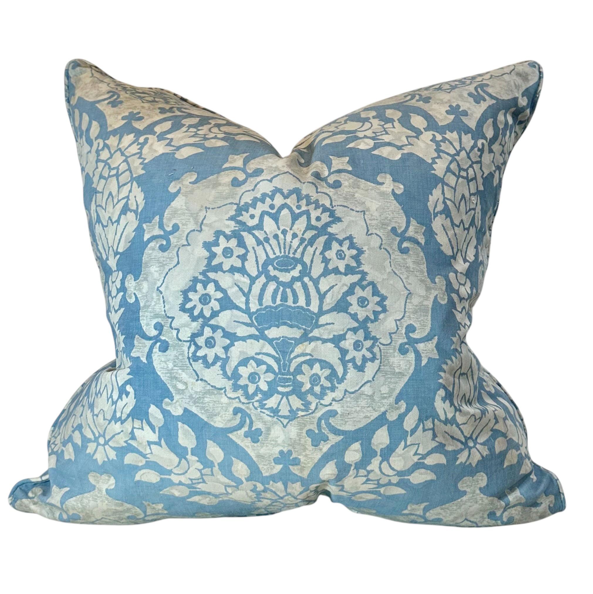 A single Fortuny pillow is a beautiful shade of blue with silver. The fabric was bought in Italy in the 1950s, and made into drapes from a couple who bought the fabric on their honeymoon. It is Fortuny was signed on the edge. The piping, self piping