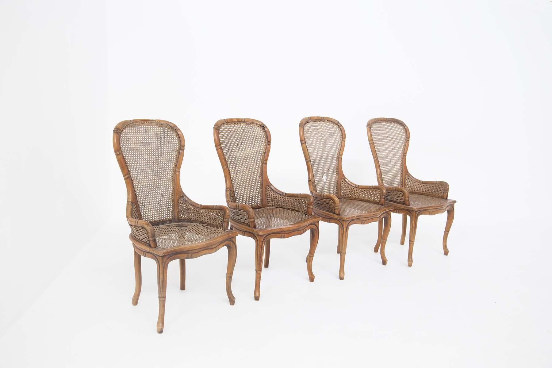 Set of four faux bamboo chairs made by Giorgetti in the 1980s. The seat and back are made of rattan. The structure is made of wood but through its realization technique similar to a bamboo cane, the armchair seems to become an exotic piece of