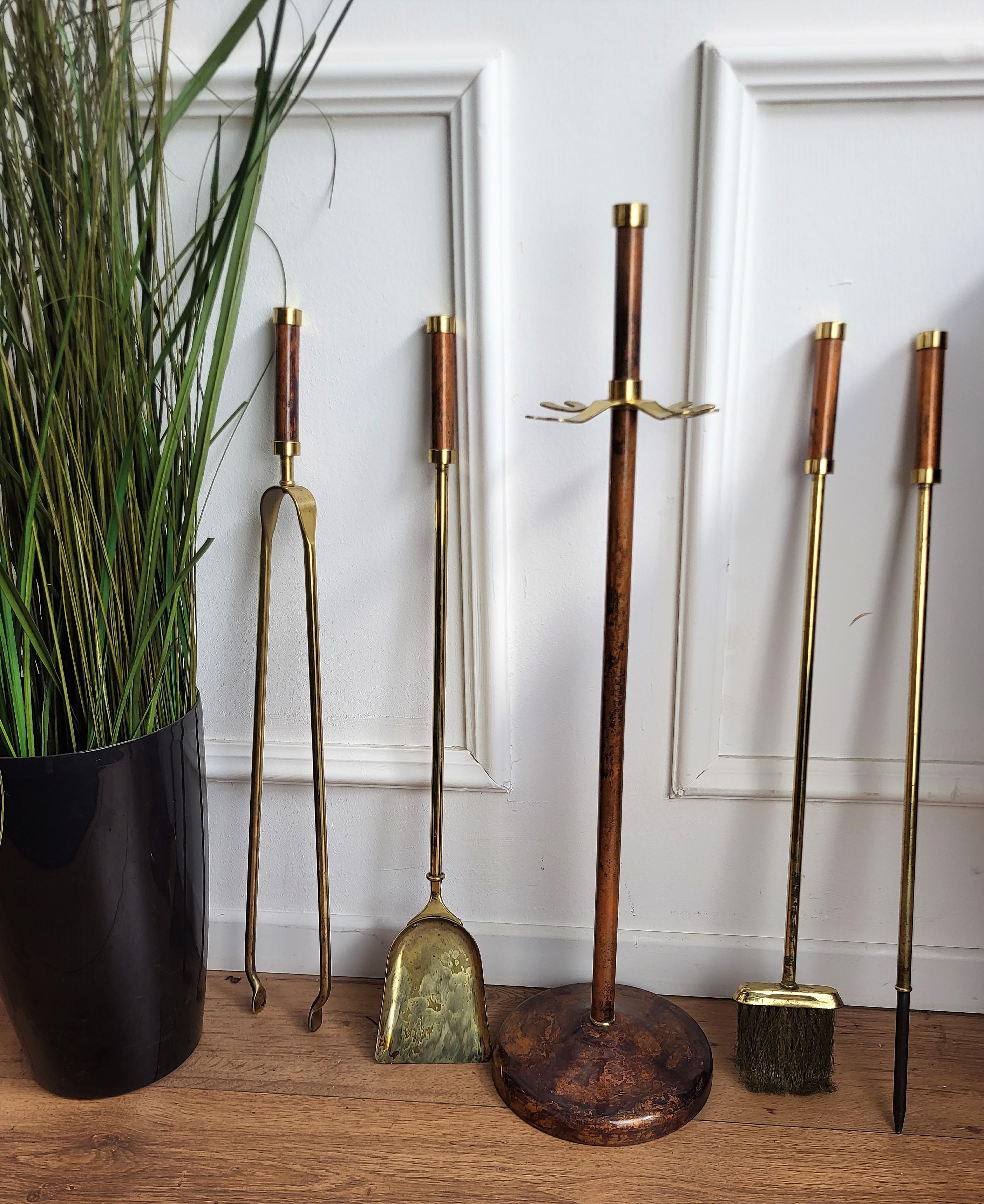 Italian brass and burl veneer wood four-pieces fire tool set with stand. The set consists of a poker, a shovel and a pair of tongs, each with an ornate handle such as the stand in beautiful shape.

.