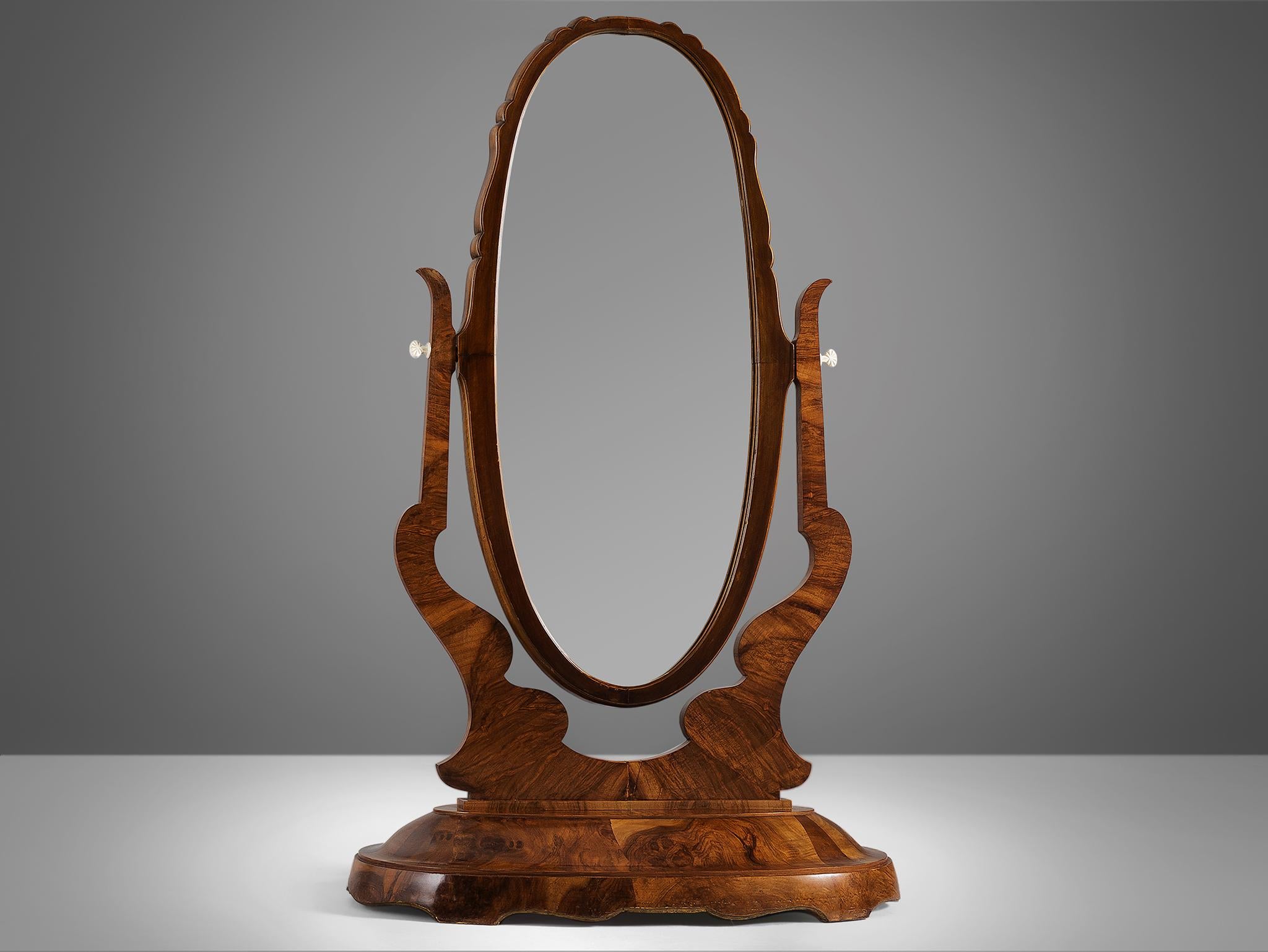 Dressing mirror, walnut burl, glass, Italy, 1940s.

Impressive and elegant dressing Italian mirror. The wood shows a wonderful grain and the walnut burl details are very beautiful and particular. The oval mirror is adjustable for easy use. The