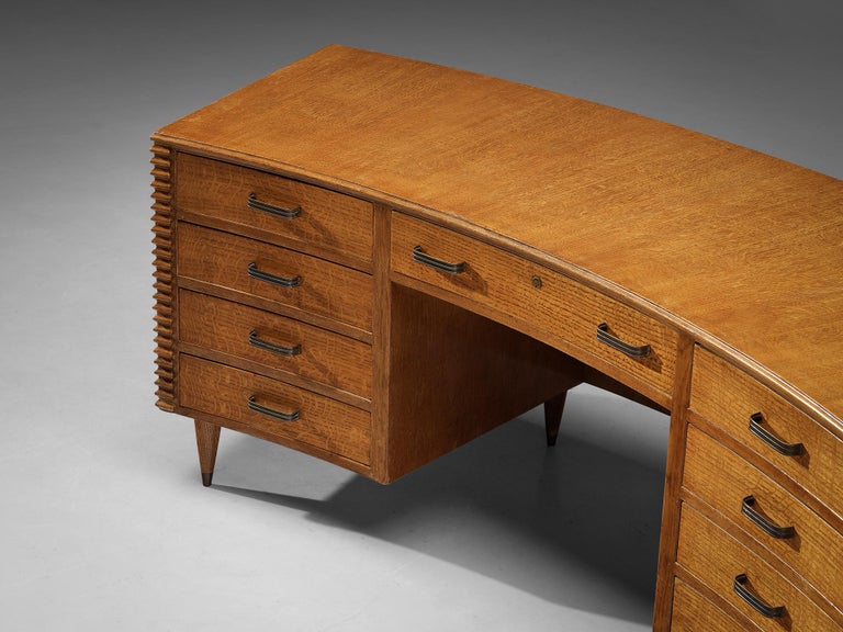 Freestanding desk, oak, brass, Italy, 1950s. 

This elegant curved freestanding desk truly radiates the quality of midcentury Italian design. Note for instance the lineair carved lines on the side and back panels of the desk, typically for Italian