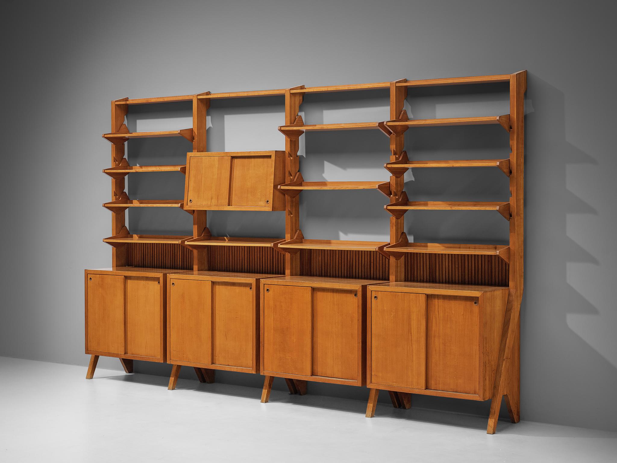 Freestanding wall unit or library, cherry, Italy, 1960s

Made by a skilled craftsman in Italy, this exceptional library unit excels in its form and composition. The bookcase reflects the design principles of the midcentury era that rose to