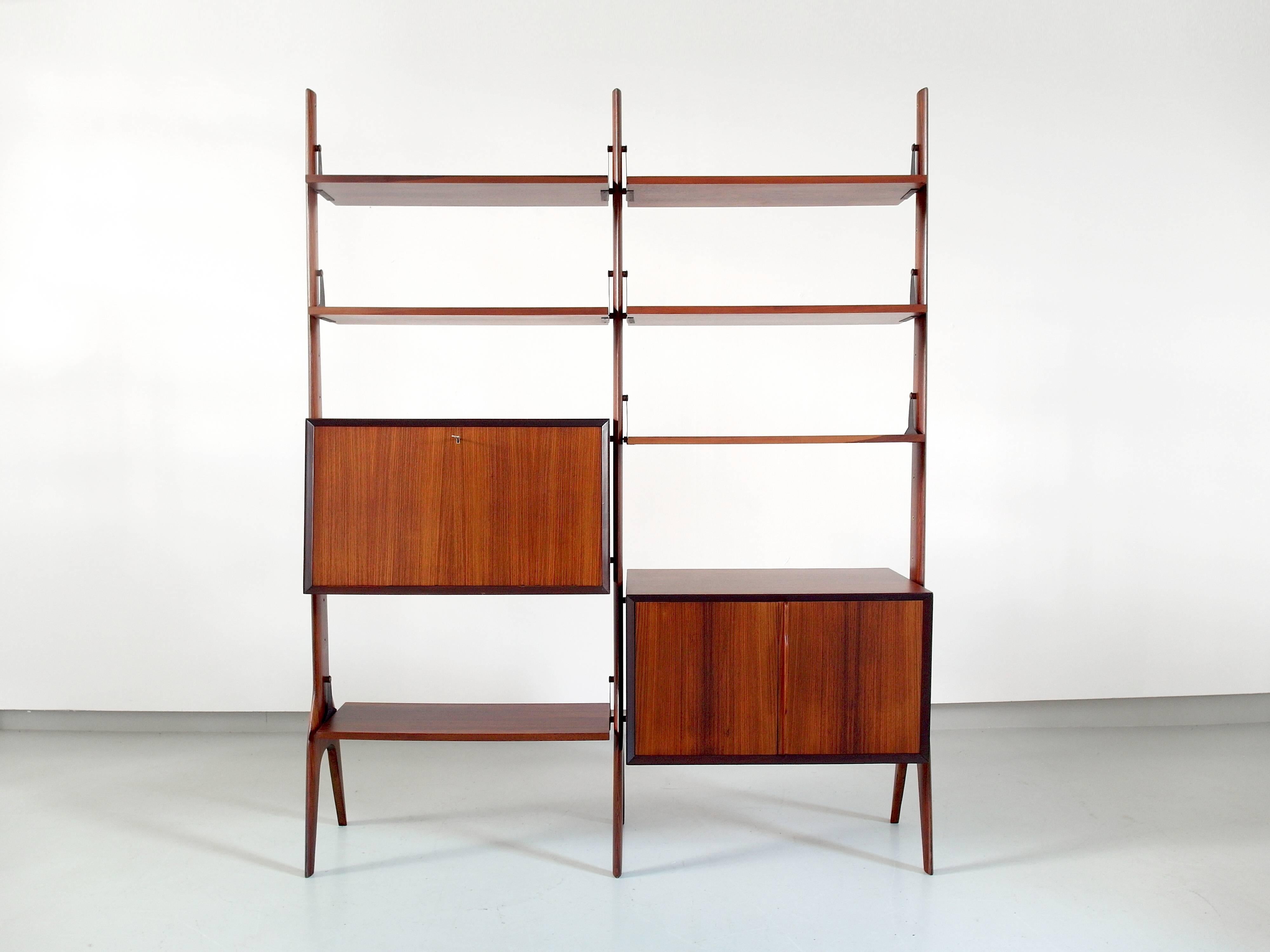 Freestanding shelving unit with sculptural details in gorgeous dark Brazilian hard wood, Italy, circa 1955

Stunning Italian freestanding shelving unit or bookcase with adjustable shelves and two cabinets. In the style of Ico Parisi, but the maker