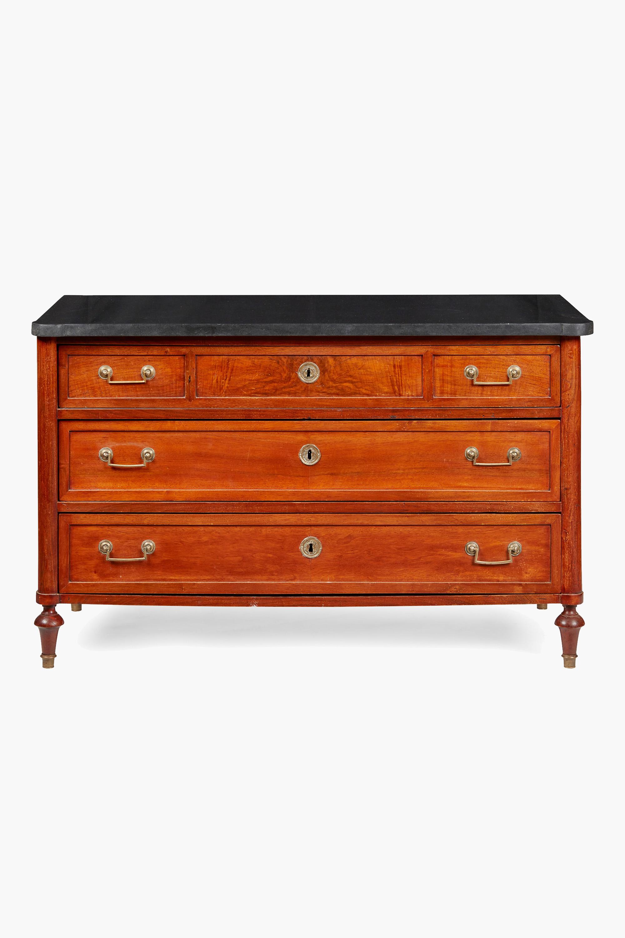 Italian fruitwood commode, Late 18th Century

Italian Neoclassical fruitwood commode with a black marble top, detailed with outset rounded corners above three long drawers flanked by pillars, raised on turned feet with brass sabot