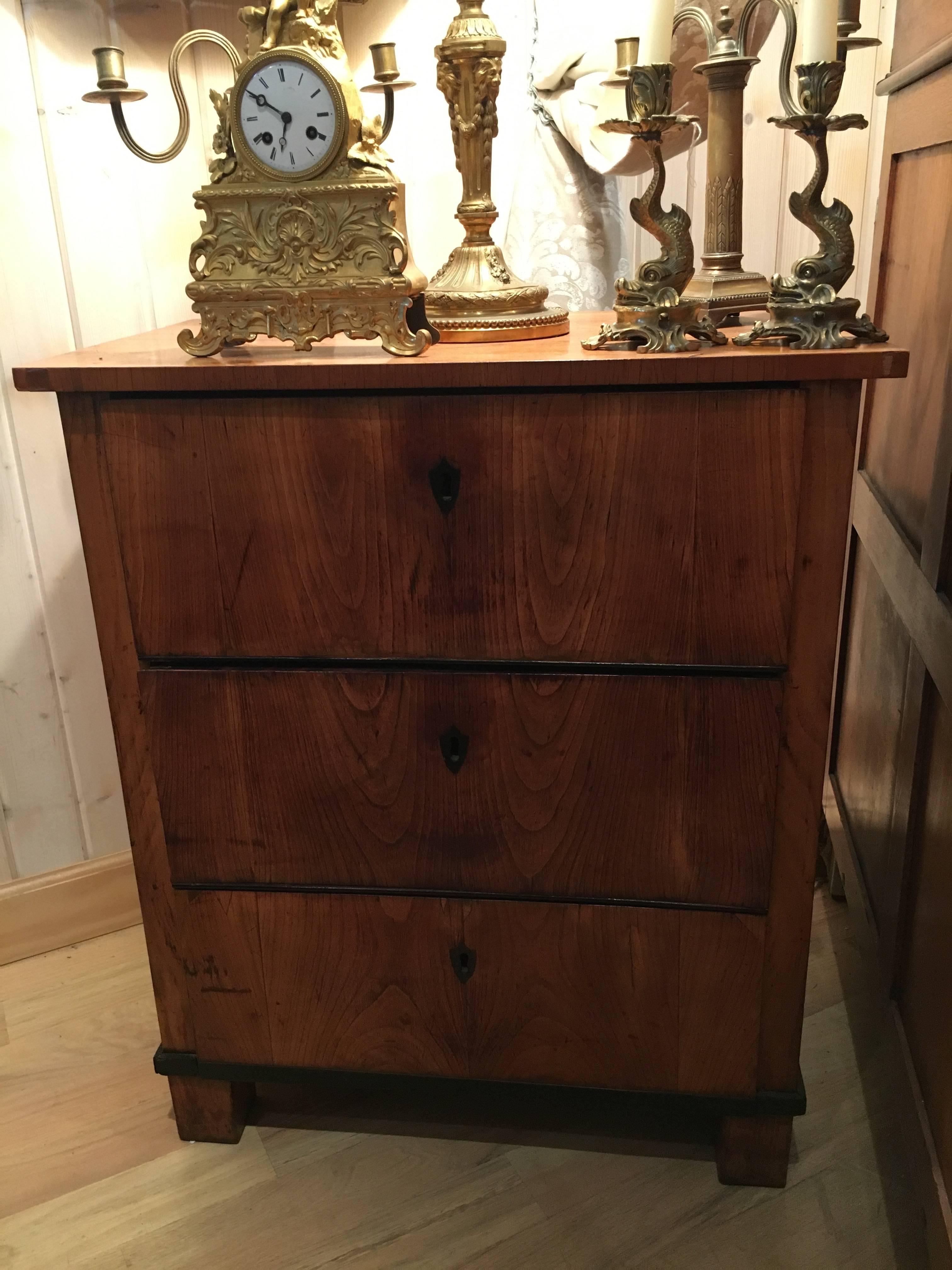 An Italian fruitwood neoclassical three-drawer chest. Top drawer drops down as a desk.   Measure: Height 30 1/2 x width 25 1/2 x depth 15 1/2 inches.
