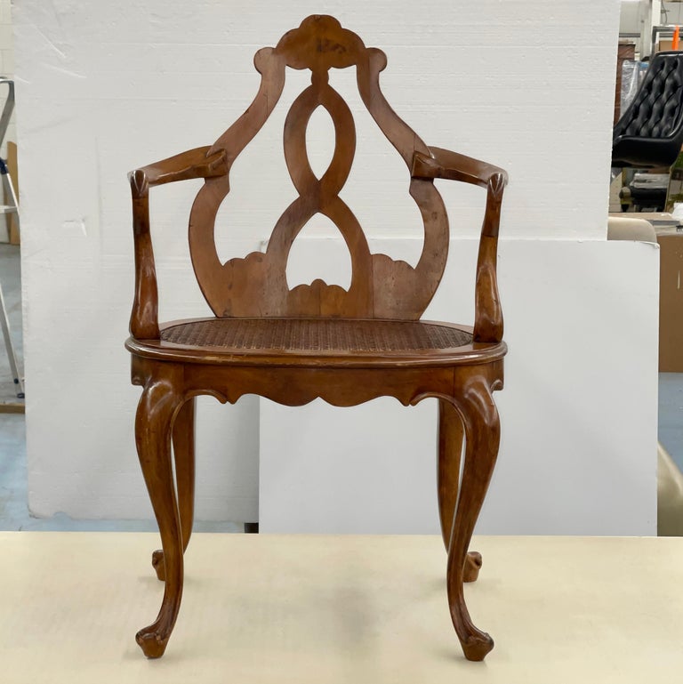 Italian fruitwood armchair with unusual scrollwork design and caned seat. Bench made, fitted with pins and dowels.

Measures: 34