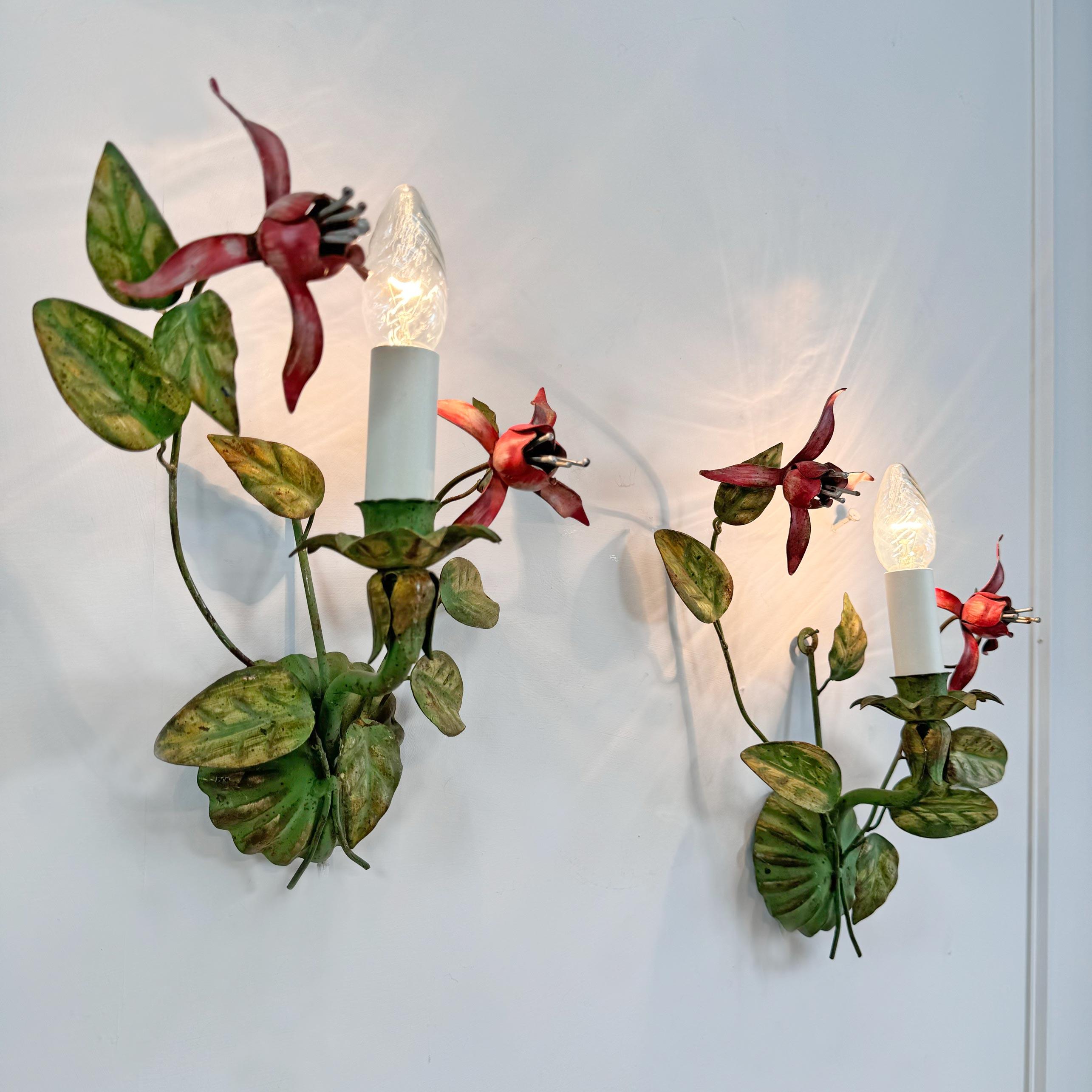 A beautiful and very rate pair of 1950's Italian hand painted wall lights, in the form of a pair of Fuchsia Flowers and foliage. In bright pinks, and natural green tones.



Each light has a single e14 (small screw in) lamp holder.



Height 35 cm x