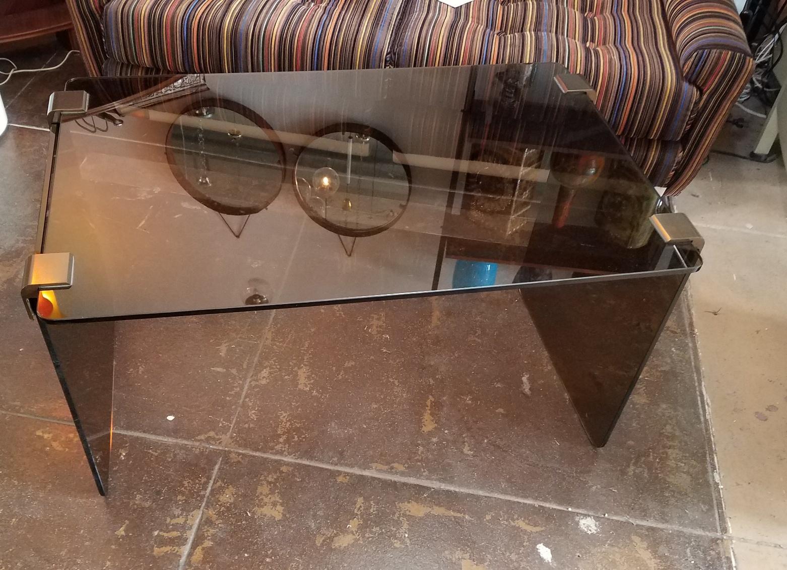 Italian 1960s smoke glass table by Pace Collection. Table can be reassemble when bronze glass holder unscrewed.
Shipping to US continental in home delivery $300