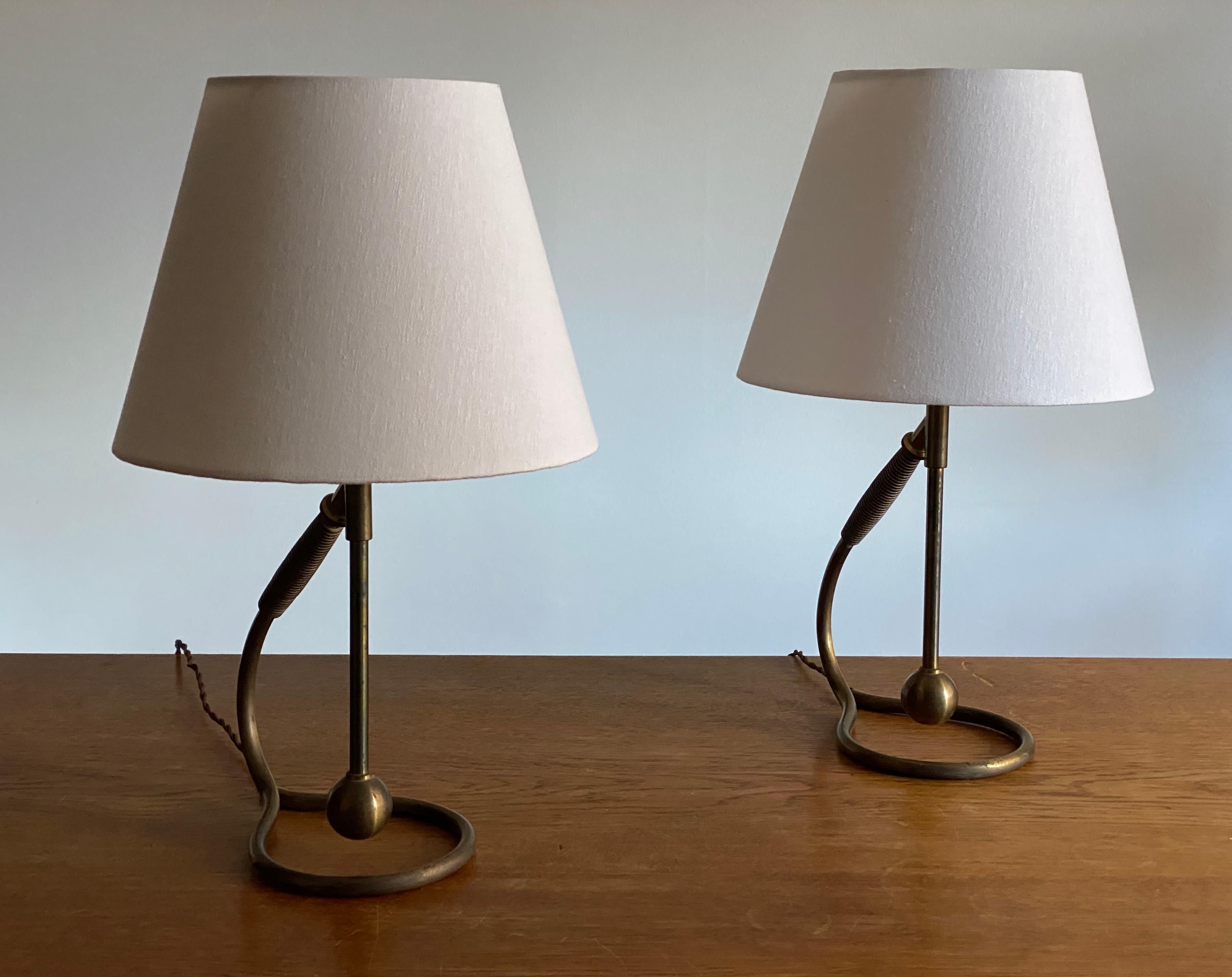 A pair of organic and adjustable table lamps. Designed and produced in Italy, 1940s. In a highly intricate and sculptural form.

Lampshades are attached for illustration and are not included in the purchase. Dimensions stated are excluding