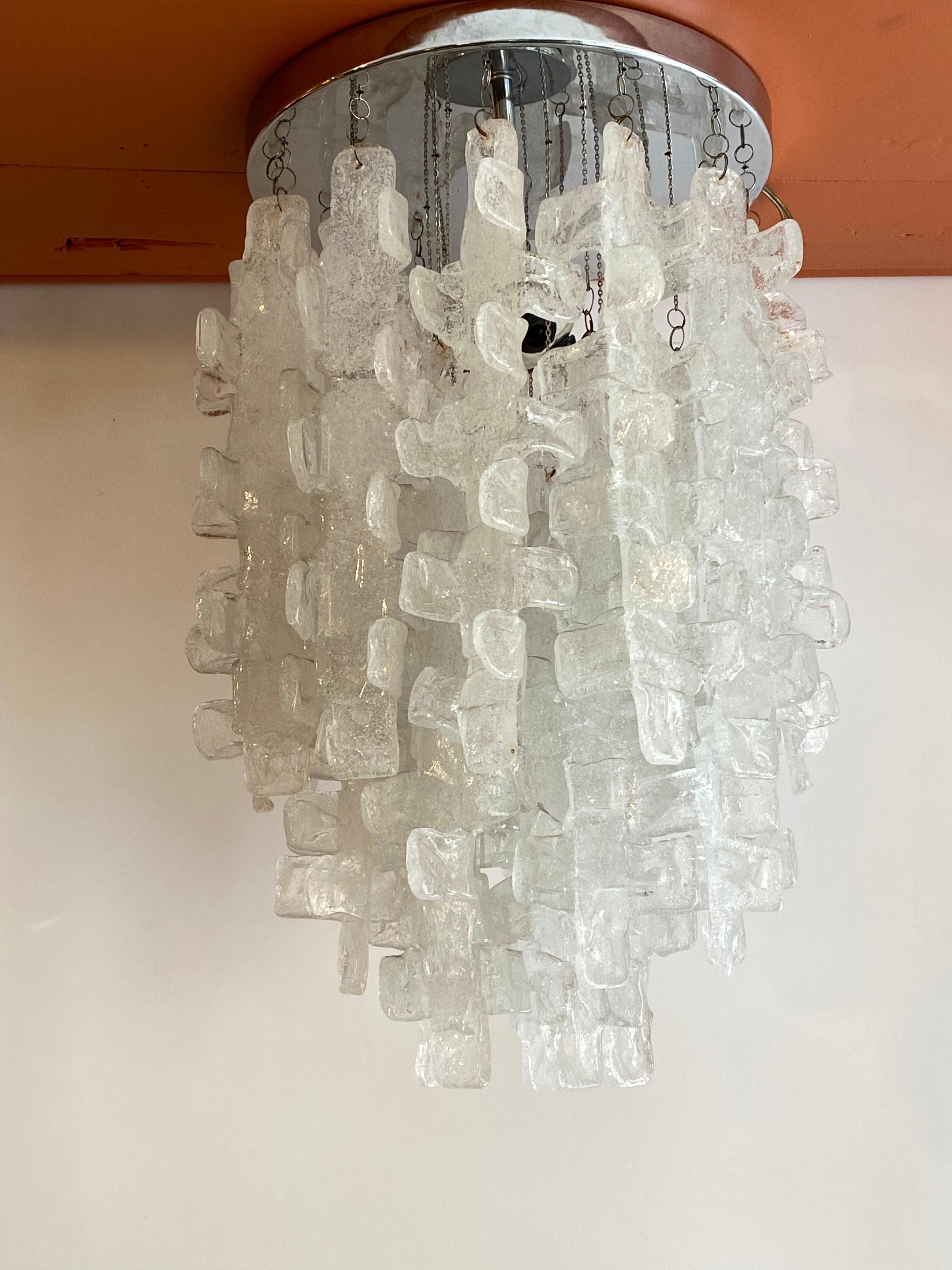 Italian fused flush mounted light fixture. Chrome round mounting ring. Each crystal hangs down with a small chain. Fixture is made up of 28 fused slag glass type pieces that measure 14