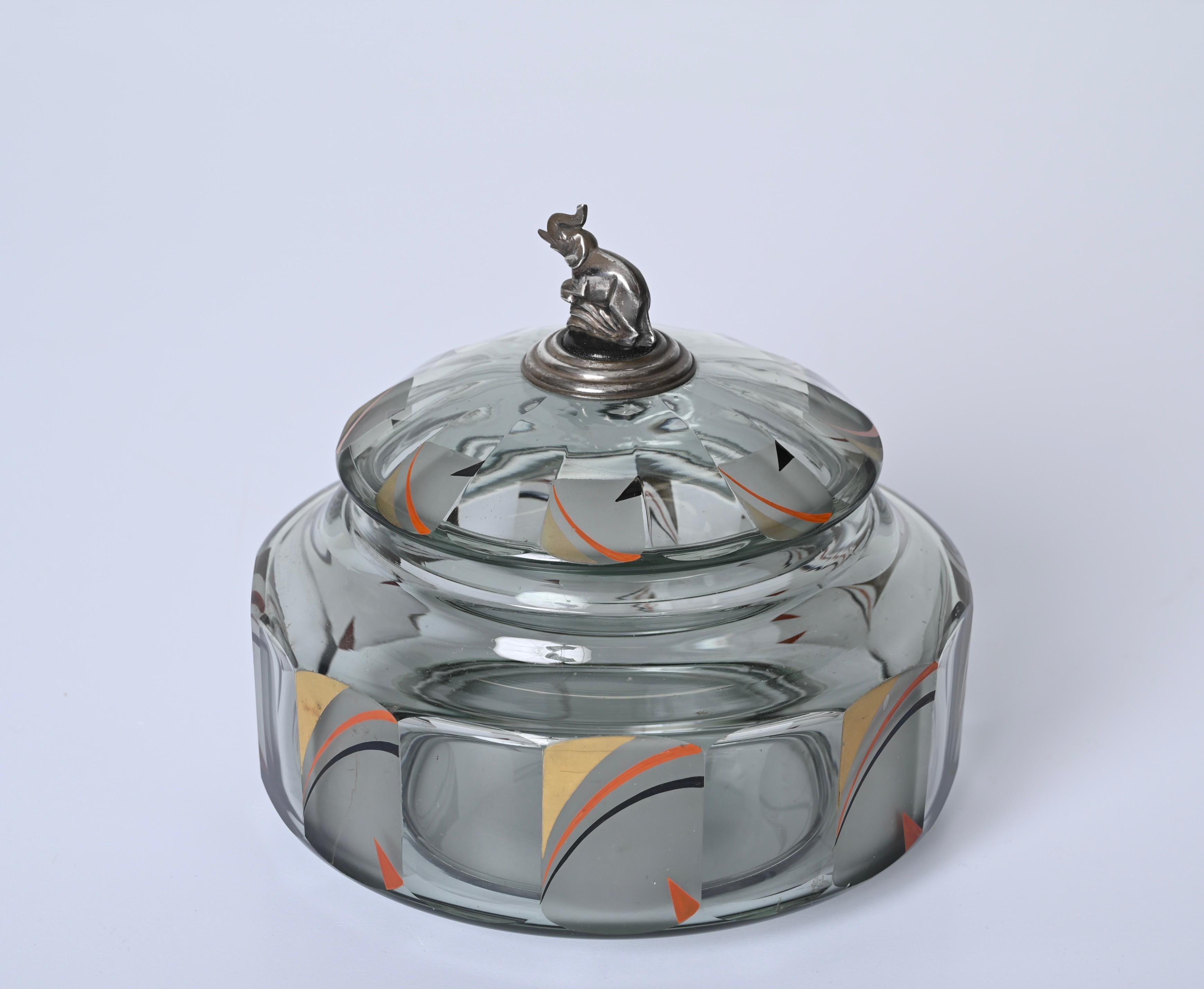 Incredible futurist multifaceted crystal glass box, this stunning piece was produced in Italy in 1933, as it features the 800 silver engraving that was used only in that specific year.

The box features gold, black and orange enameled decorations