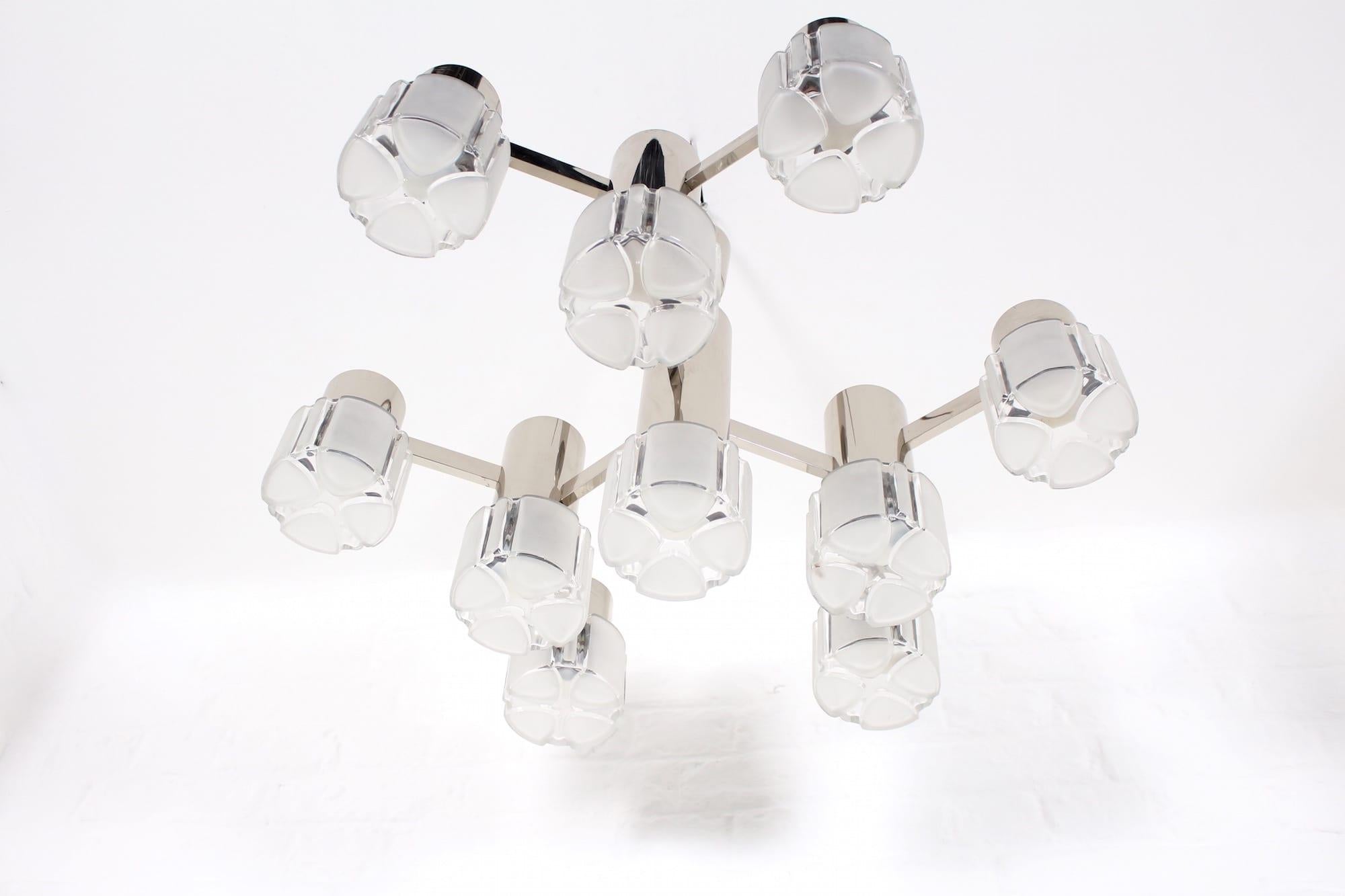 Beautiful Italian style and high quality manufacturing for this mid-century chandelier designed by Gaetano Sciolari for Mazzega in the early 1970s. This 9 lights chrome and Murano glass chandelier will be ideal to highlight a lounge living room, a