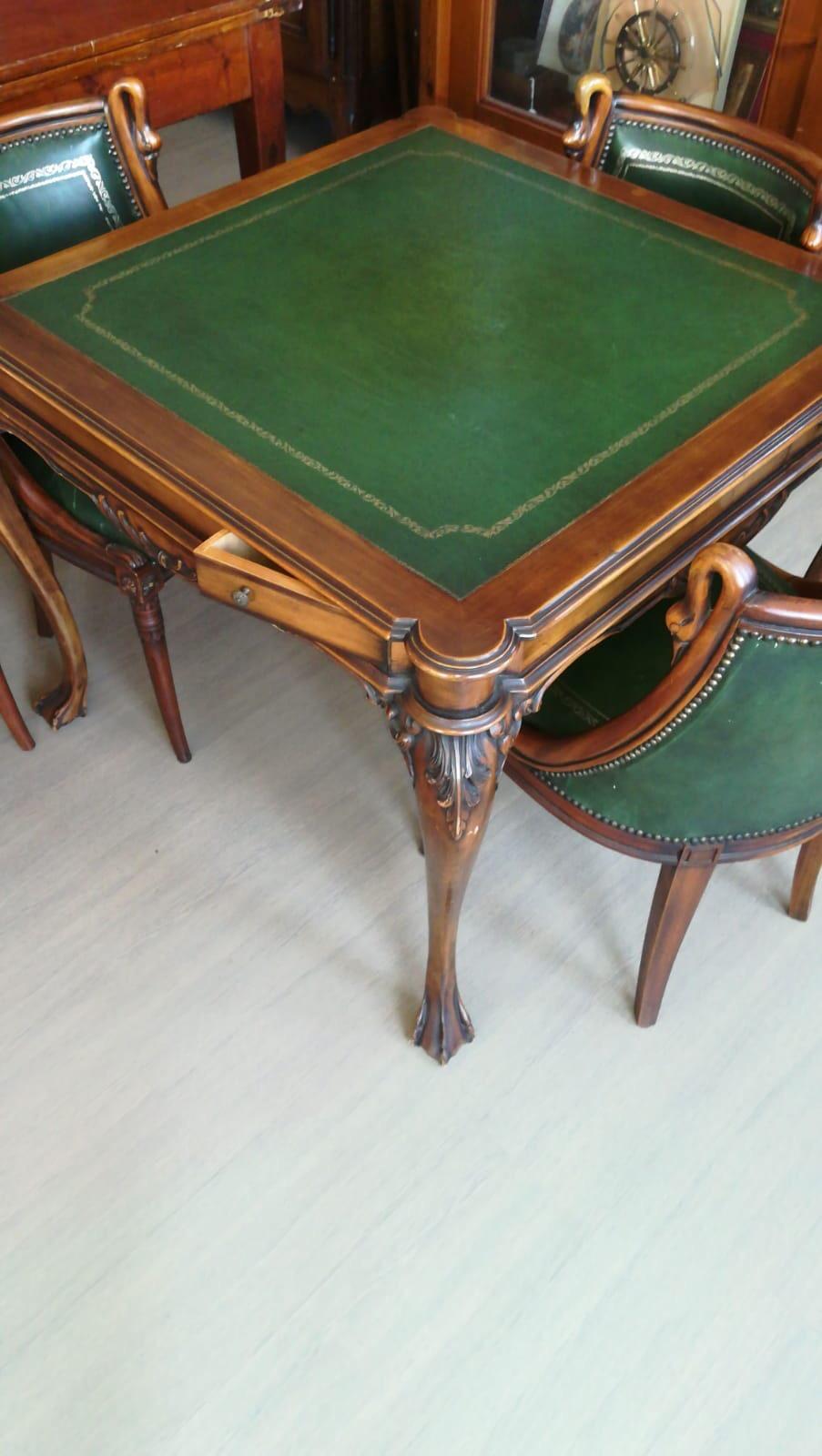 Carved walnut set of square table and four chairs beautifully decorated with bird's heads, upholstered with green leather. A lizard table lamp included in the set.
Italy, circa 1950.