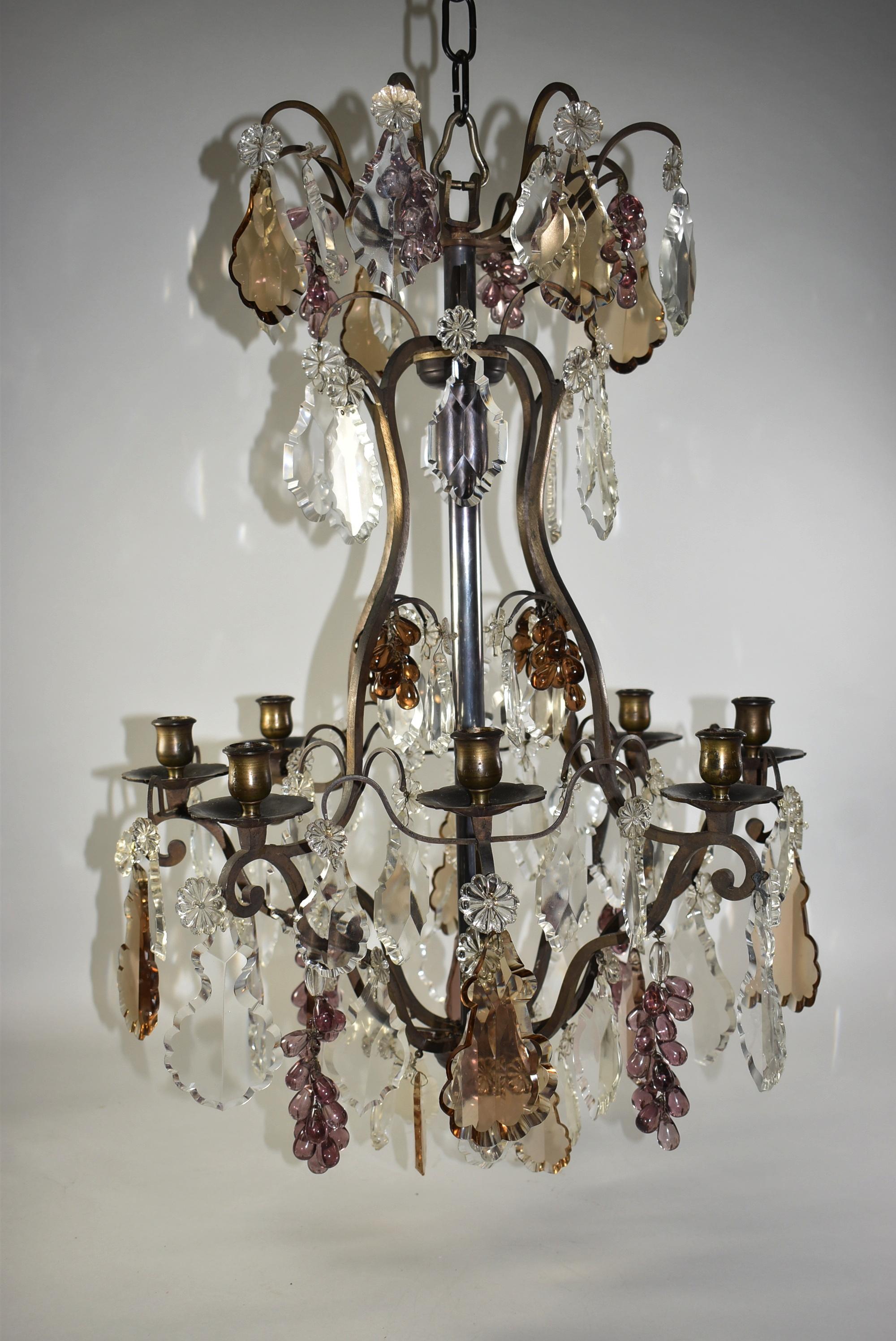 Italian Genovese candle non electric chandelier with eight arms. Bronze tone frame holds decorative crystal flowers and clusters of purple and amber grapes. 20