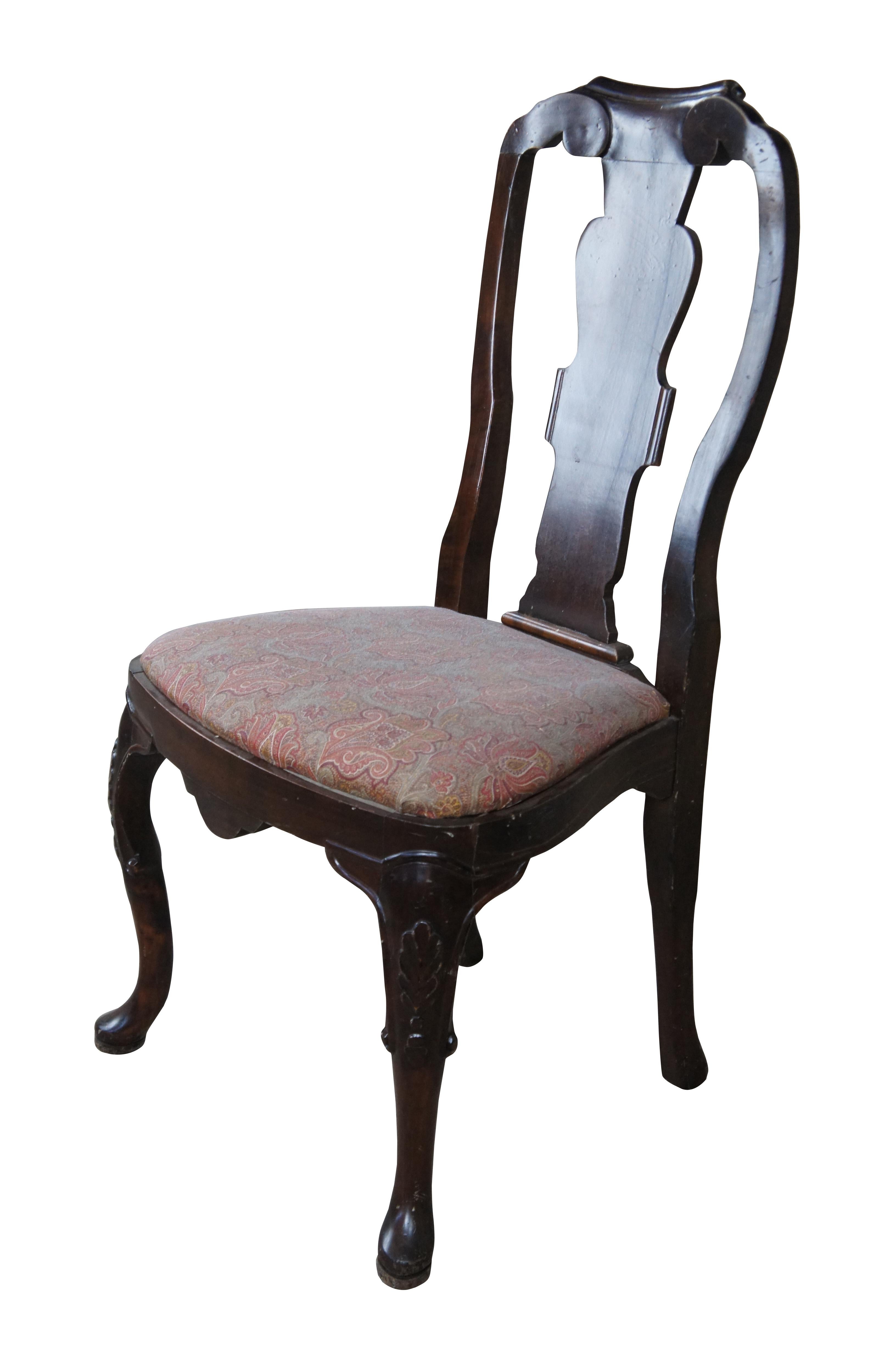 Italian side chair, circa last quarter 20th century.  Featured an aged appearance in Queen Anne styling with long slender back featuring scrolled accents.  Seat is upholstered with paisley design over cabriole legs with carved knees.