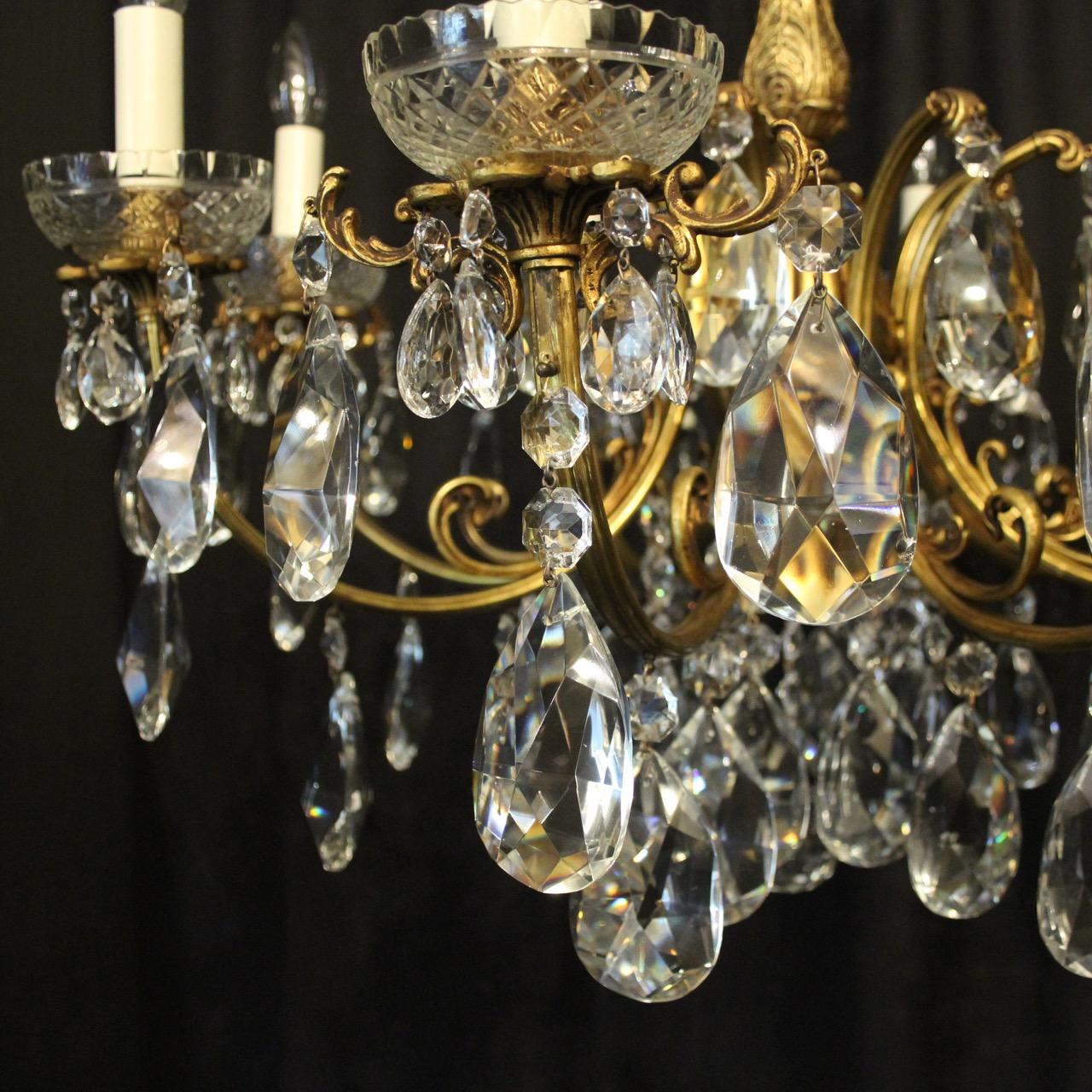 A quality Italian gilded bronze and crystal 8-light antique chandelier, the foliated leaf scrolling arms with glass bobeche drip pans and leaf candle sconces, issuing from an ornate central column with large acanthus leaf and glass baluster canopy,