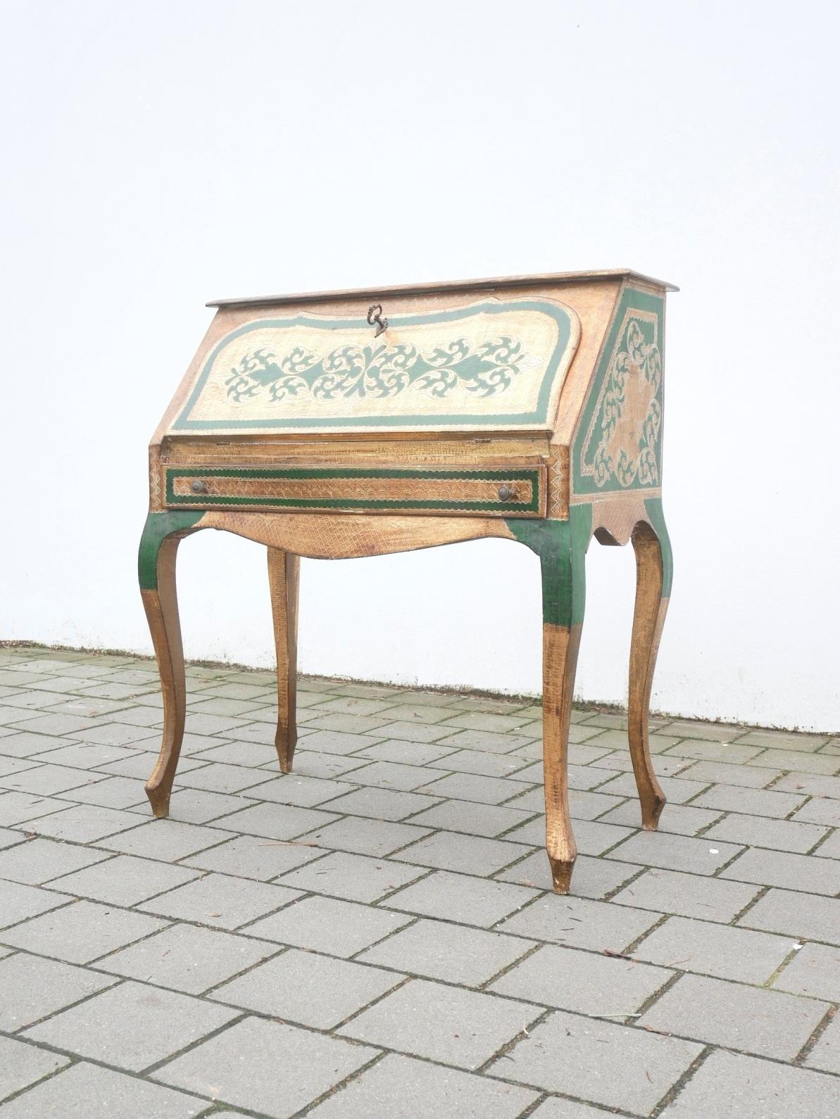 Rare midcentury Italian secretary set : hand decorated foldable writing desk with green lacquering and gold leaf covered wooden corpus. Matching a period full brass chair.
