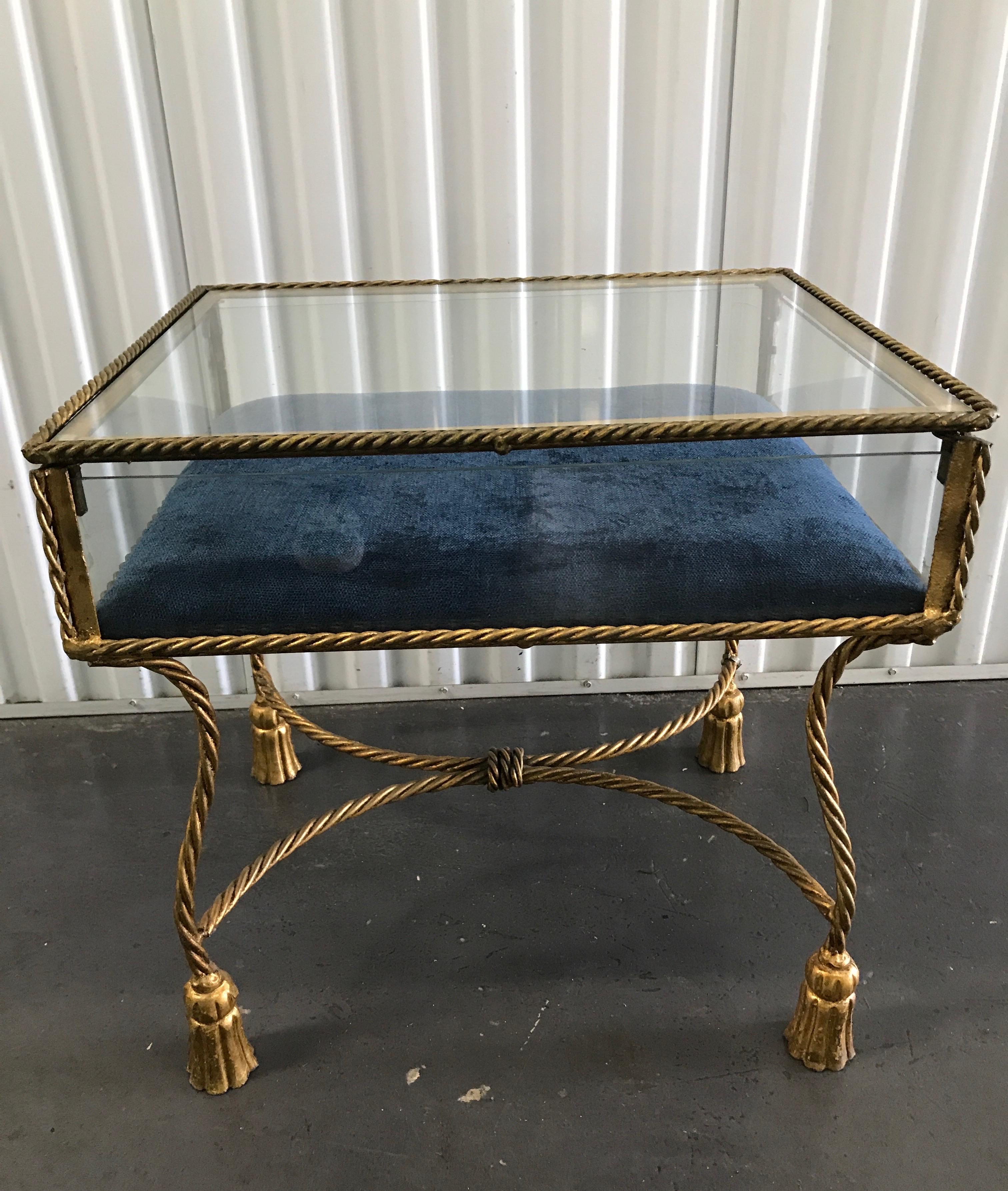 Hollywood Regency rope and tassel gilded iron display box table with blue velvet interior.