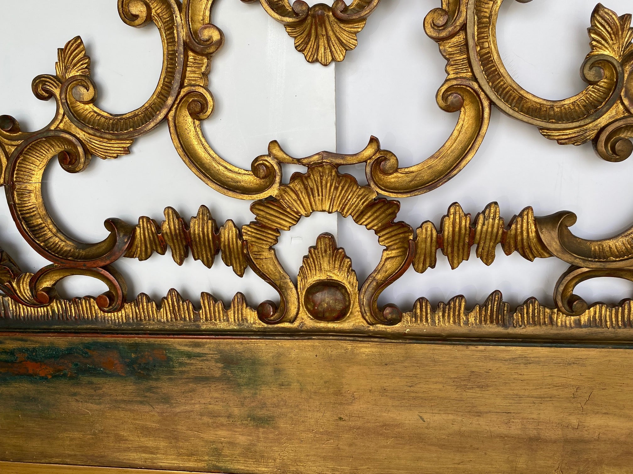 A heavily carved Italian gilded headboard, circa 1950s.