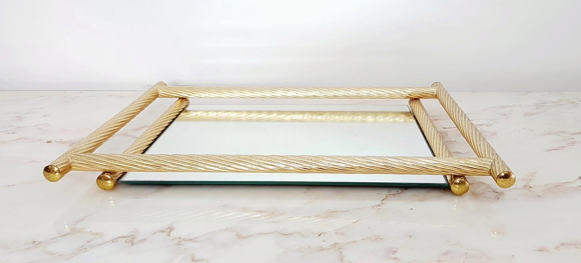 Rectangular gilded tray with a mirrored base and a frame imitating a twisted rope.