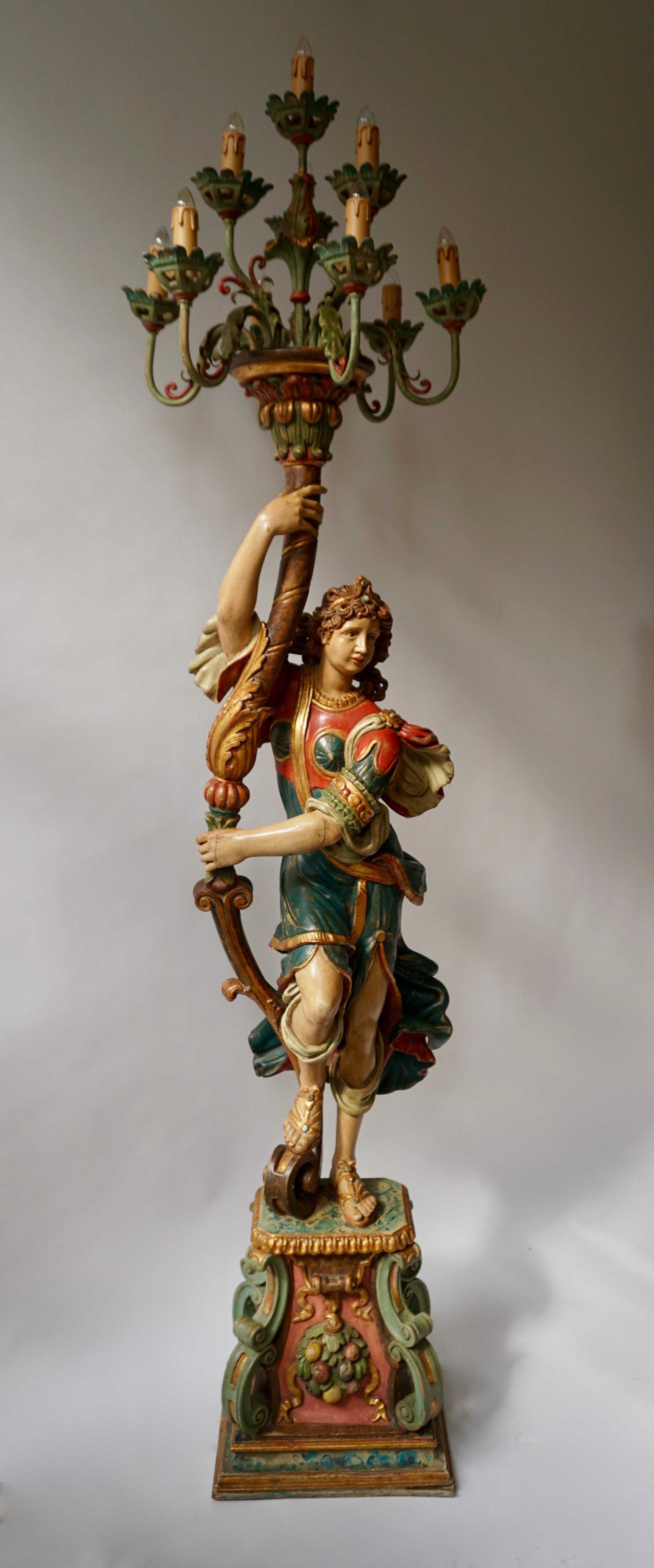 This is an exquisite decorative Venetian style candelabra floor lamp!

This rare and elegant Italian midcentury carved wood and polychrome painted figure is holding a ten-arm candelabra. Each arm of color tole candelabra is decorated with foliage